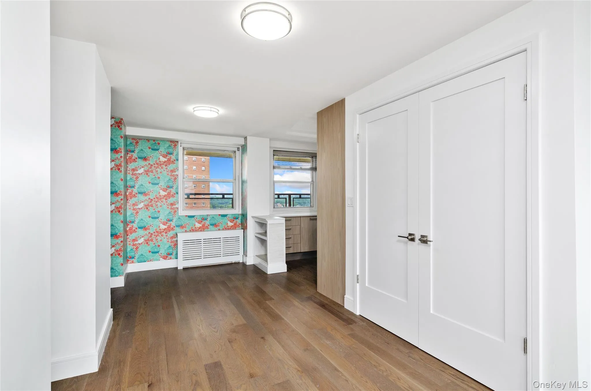 Corridor featuring baseboards and wood finished floors Corridor featuring baseboards and wood finished floors