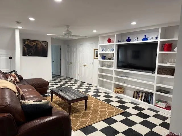 Living area with tile patterned floors, a ceiling fan, and recessed lighting Living area with tile patterned floors, a ceiling fan, and recessed lighting