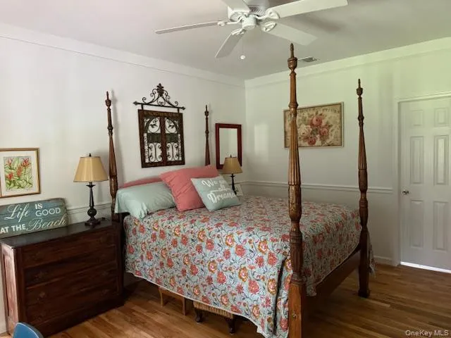 Bedroom featuring wood finished floors and ceiling fan Bedroom featuring wood finished floors and ceiling fan