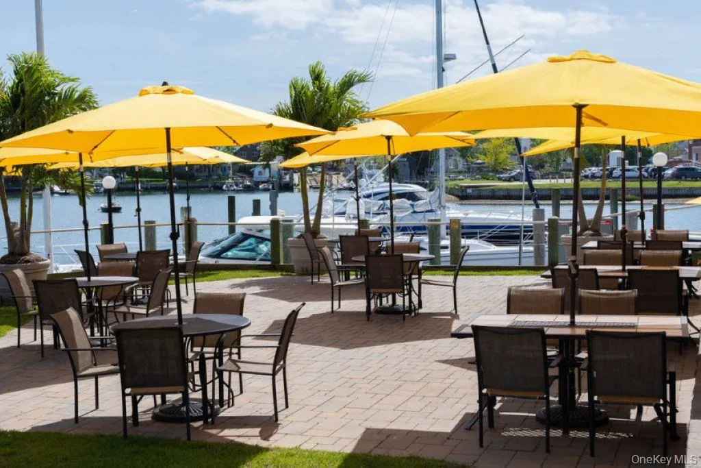 View of patio featuring outdoor dining space and a water view View of patio featuring outdoor dining space and a water view