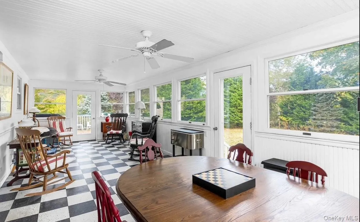 Sunroom with tile patterned floors and crown molding Sunroom with tile patterned floors and crown molding