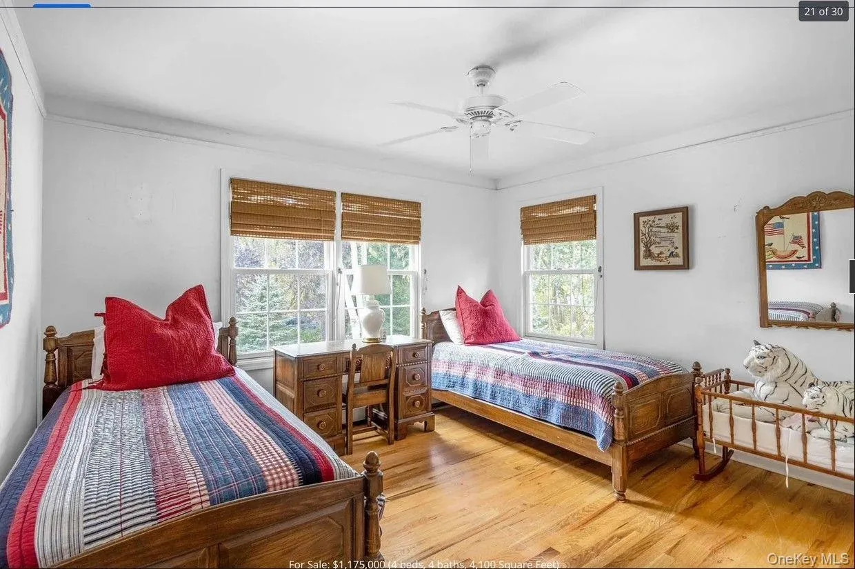 Bedroom featuring light wood-style flooring, a ceiling fan, and ornamental molding Bedroom featuring light wood-style flooring, a ceiling fan, and ornamental molding