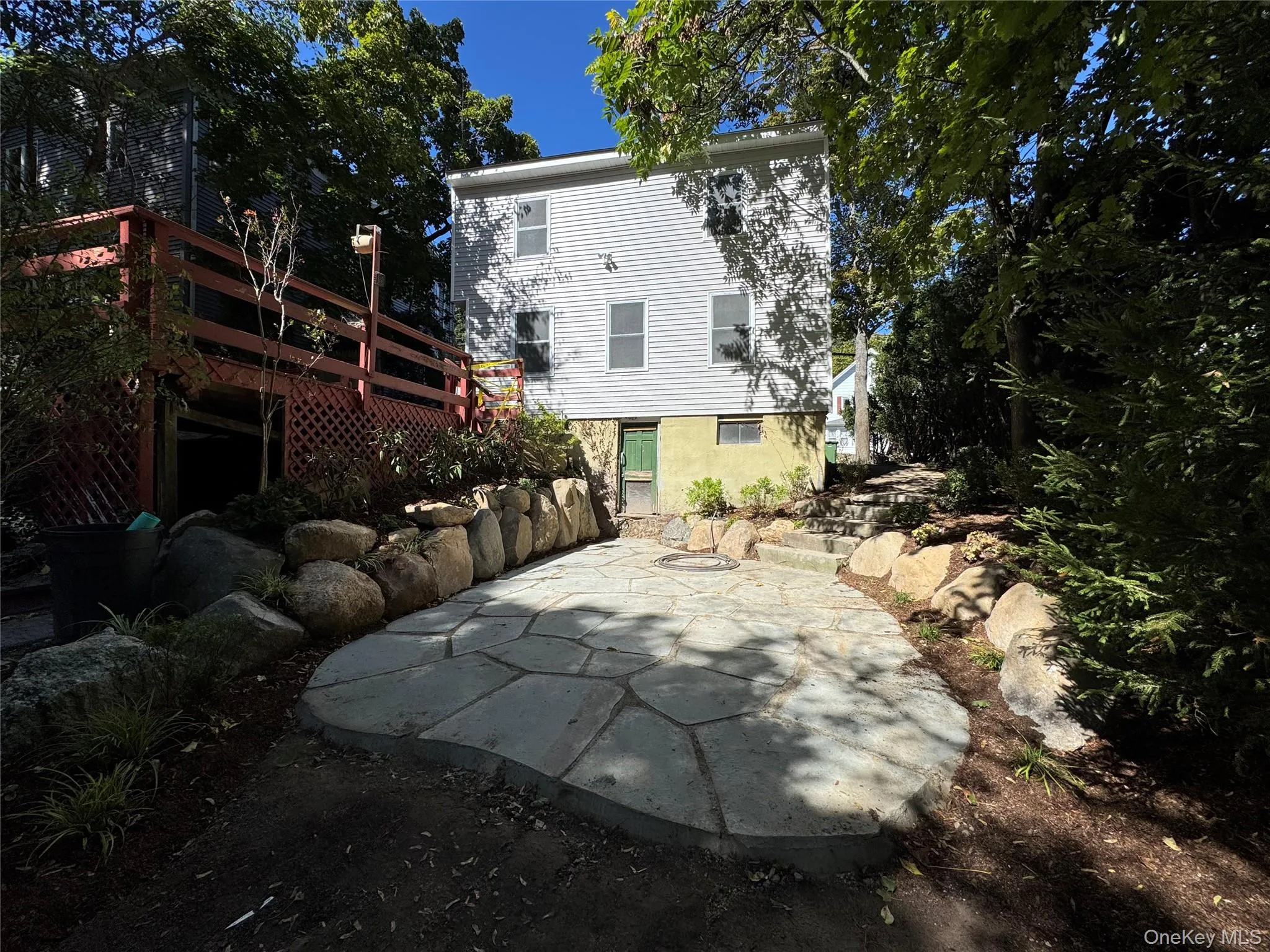 Back of property featuring a patio area and a wooden deck Back of property featuring a patio area and a wooden deck