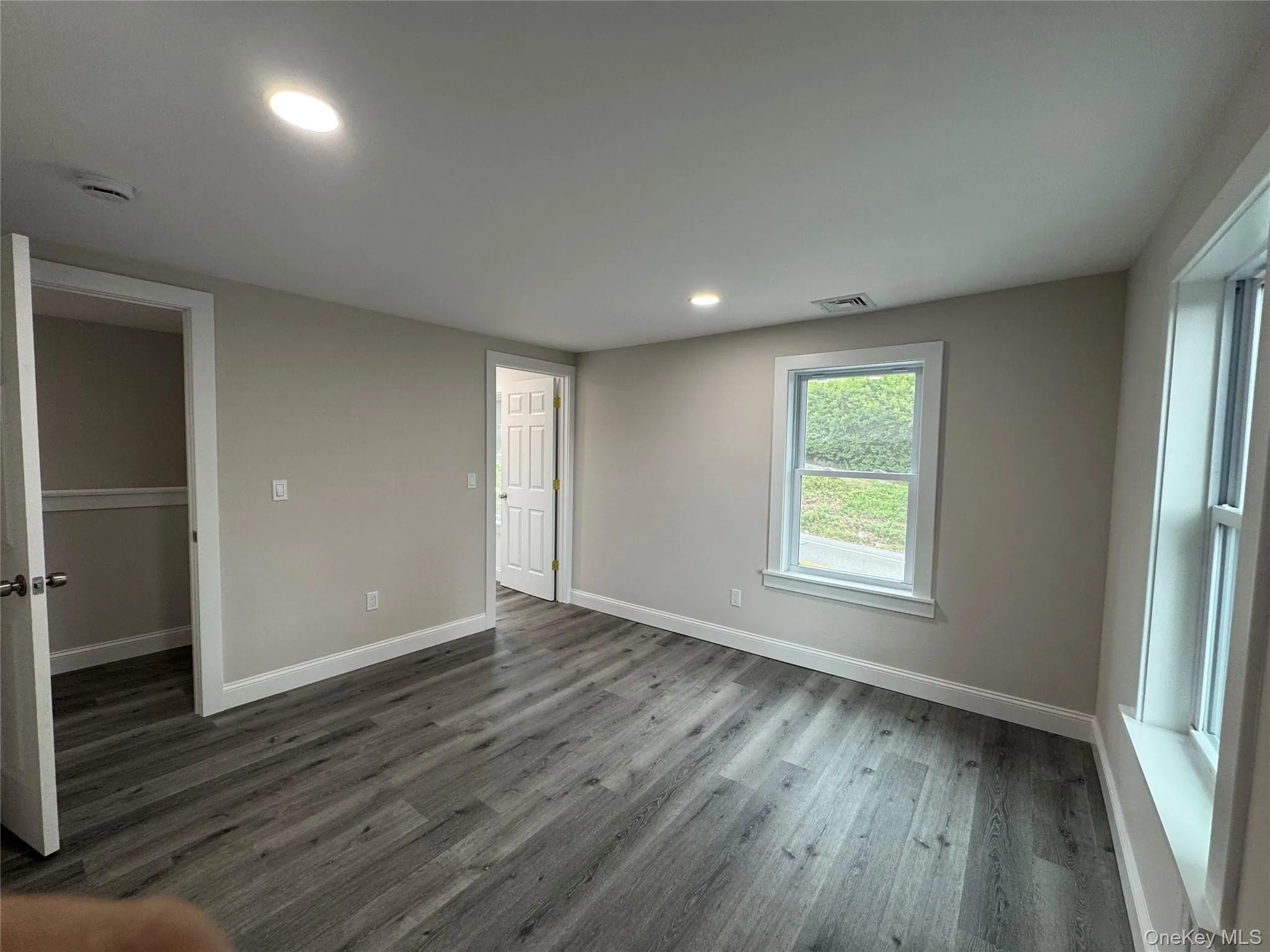 Unfurnished bedroom featuring recessed lighting, wood finished floors, and a spacious closet Unfurnished bedroom featuring recessed lighting, wood finished floors, and a spacious closet