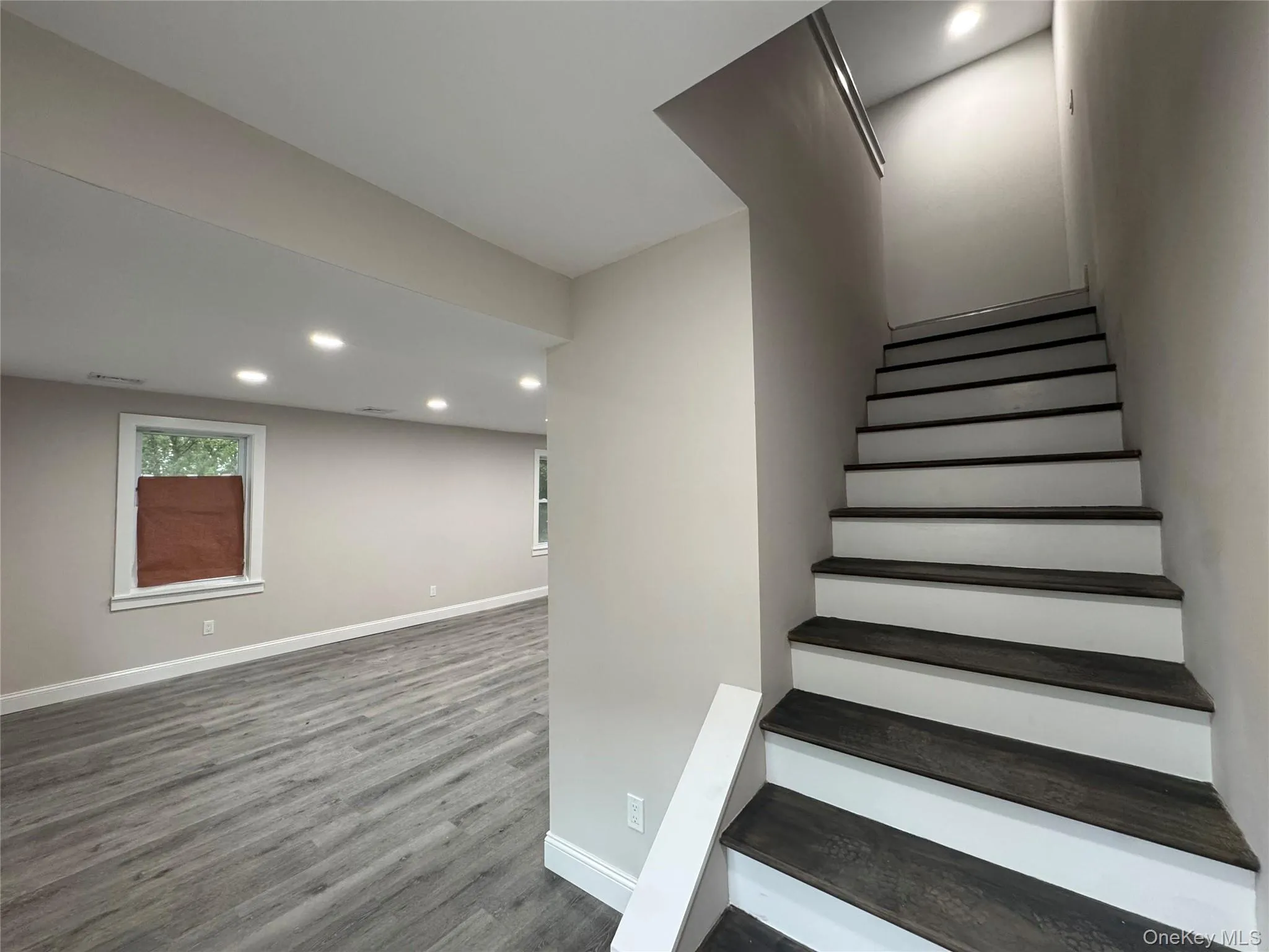 Stairs with recessed lighting and wood finished floors Stairs with recessed lighting and wood finished floors