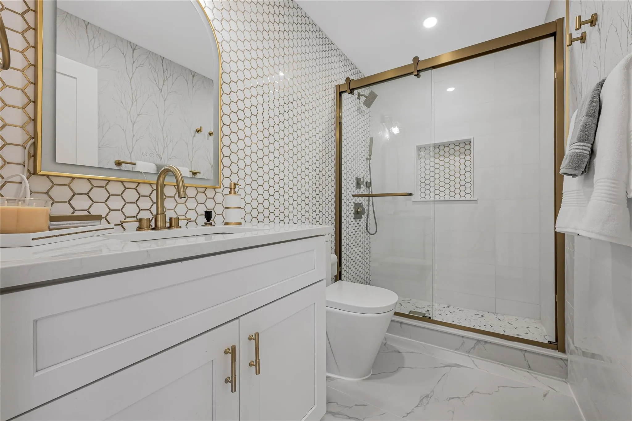 Full bathroom featuring vanity, a stall shower, marble finish flooring, and recessed lighting Full bathroom featuring vanity, a stall shower, marble finish flooring, and recessed lighting