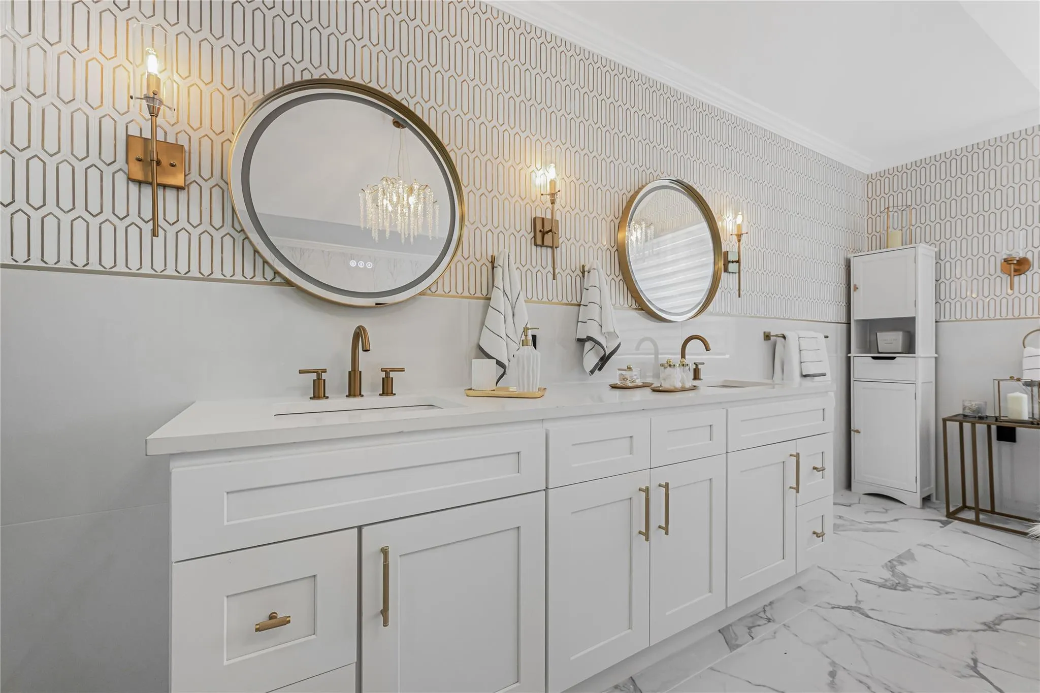 Bathroom with wallpapered walls, double vanity, marble finish floors, and ornamental molding Bathroom with wallpapered walls, double vanity, marble finish floors, and ornamental molding