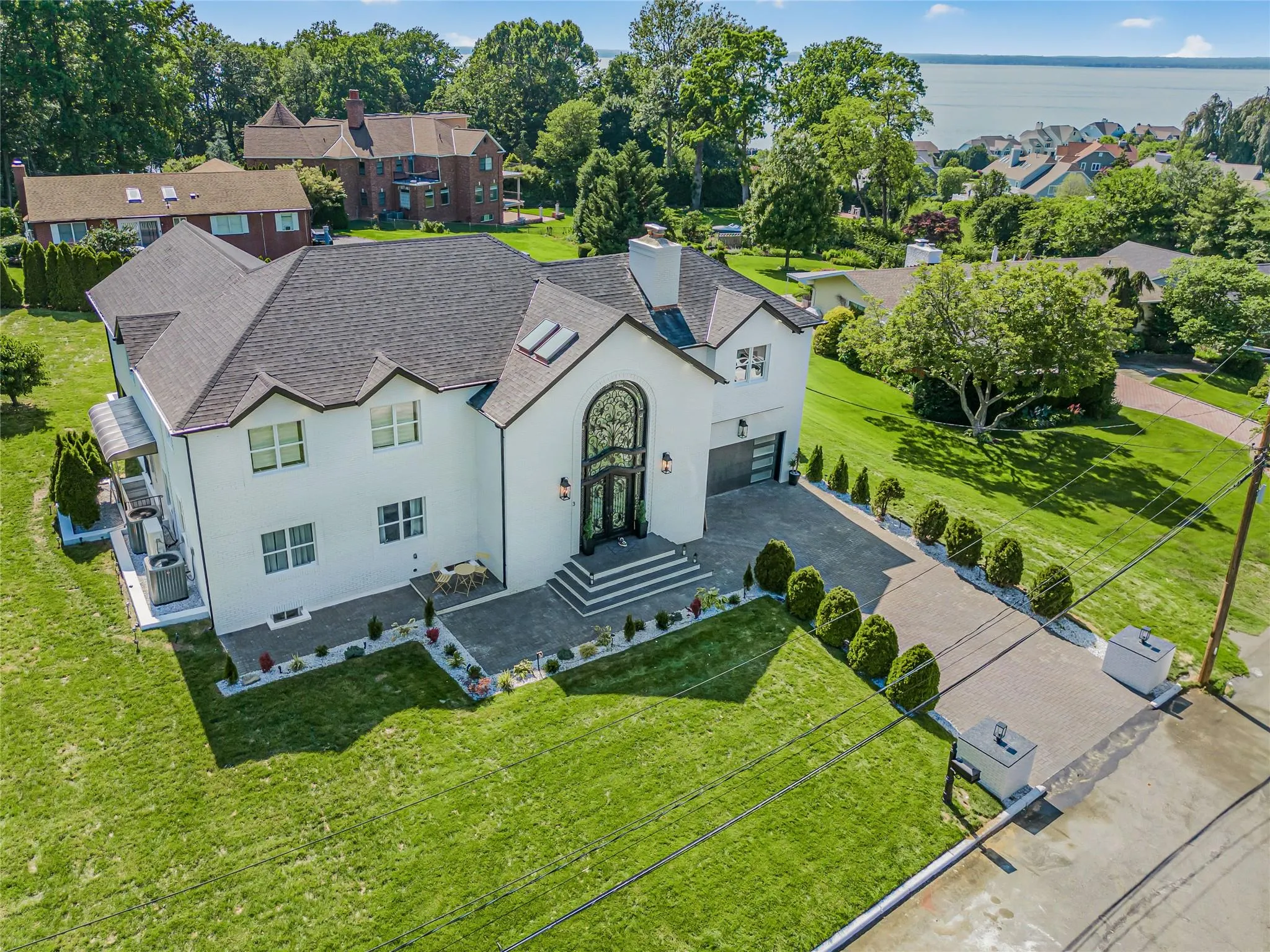 Aerial perspective of suburban area featuring a large body of water Aerial perspective of suburban area featuring a large body of water