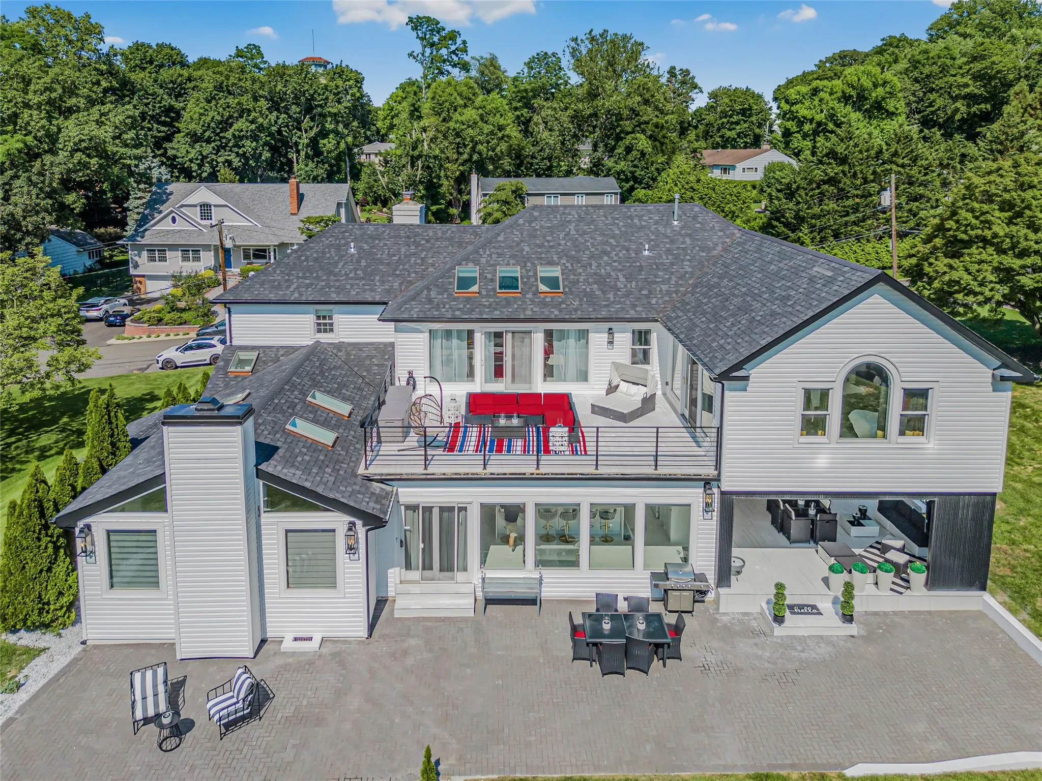 Back of house featuring outdoor lounge area, a patio area, a chimney, and a balcony Back of house featuring outdoor lounge area, a patio area, a chimney, and a balcony