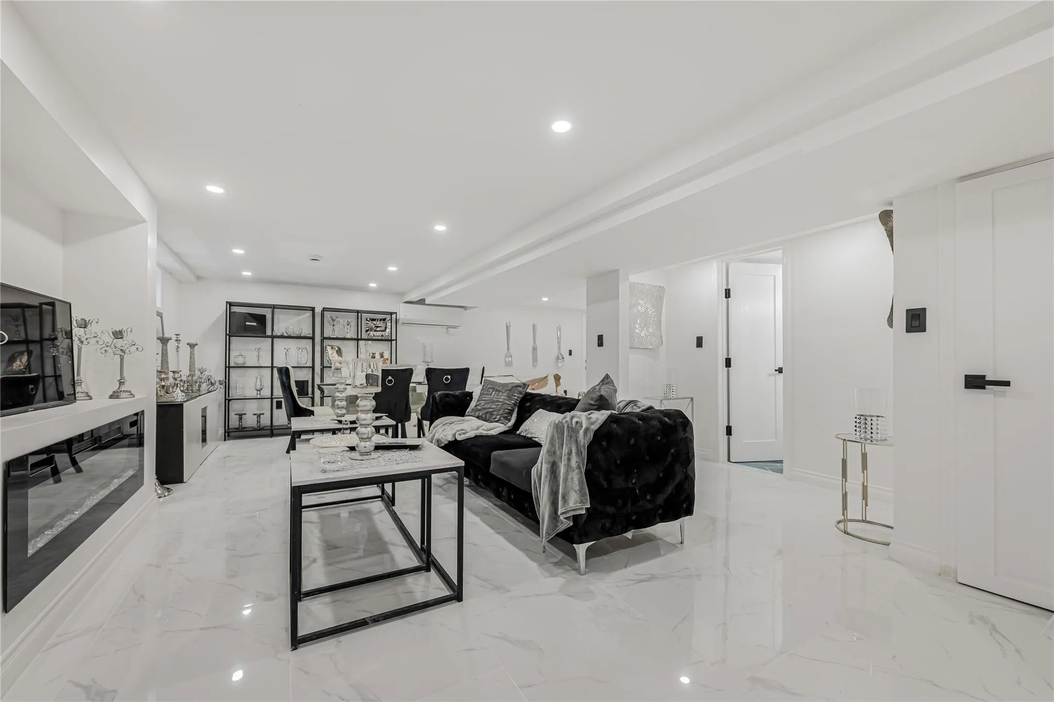 Living area with light marble finish flooring and recessed lighting Living area with light marble finish flooring and recessed lighting