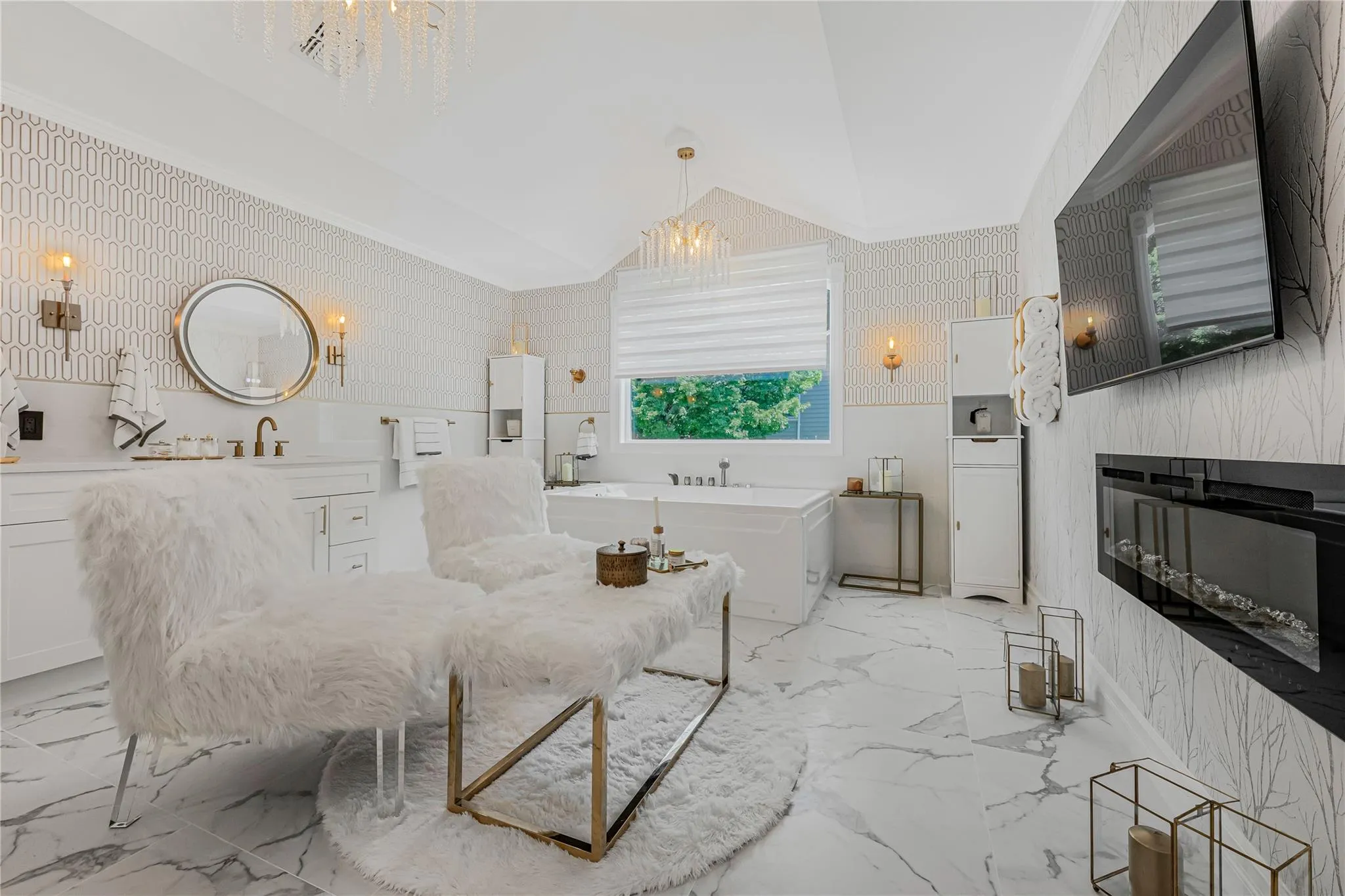 Bathroom with a freestanding bath, marble finish flooring, lofted ceiling, wallpapered walls, and vanity Bathroom with a freestanding bath, marble finish flooring, lofted ceiling, wallpapered walls, and vanity