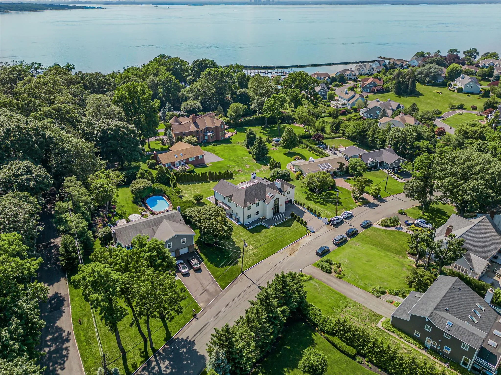 Aerial perspective of suburban area featuring a large body of water Aerial perspective of suburban area featuring a large body of water