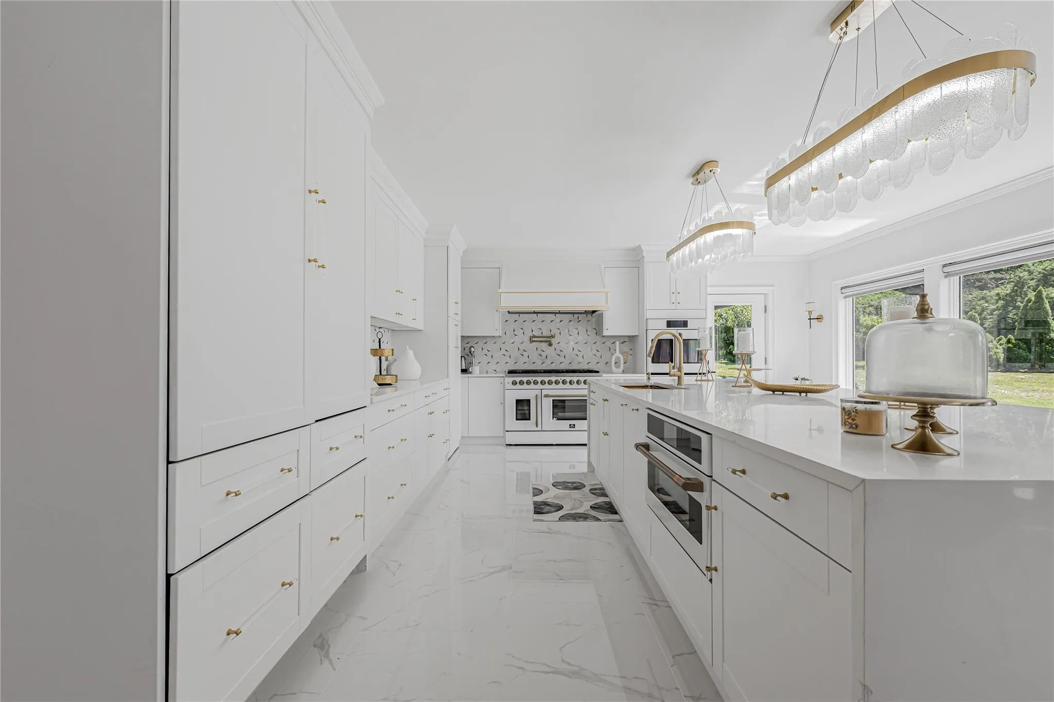 Kitchen with light marble finish floors, white appliances, white cabinets, tasteful backsplash, and light countertops Kitchen with light marble finish floors, white appliances, white cabinets, tasteful backsplash, and light countertops