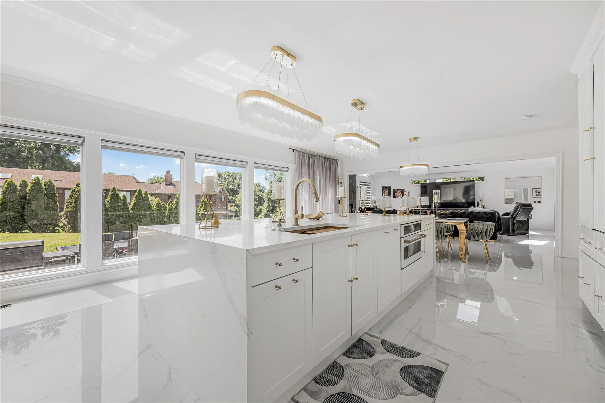 Kitchen with healthy amount of natural light, open floor plan, a kitchen island with sink, and white cabinets Kitchen with healthy amount of natural light, open floor plan, a kitchen island with sink, and white cabinets