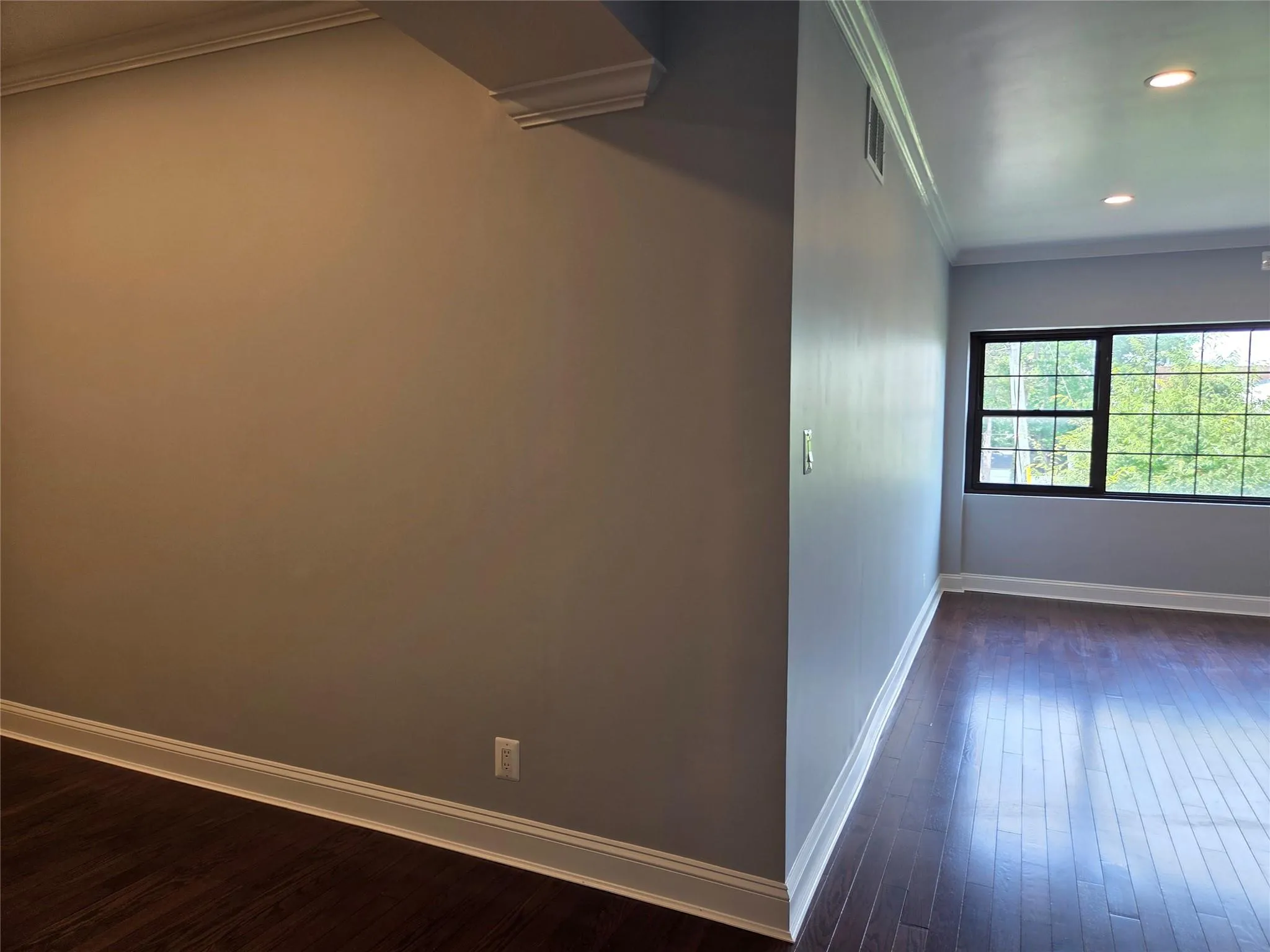 Spare room featuring crown molding, dark wood-style flooring, and recessed lighting Spare room featuring crown molding, dark wood-style flooring, and recessed lighting
