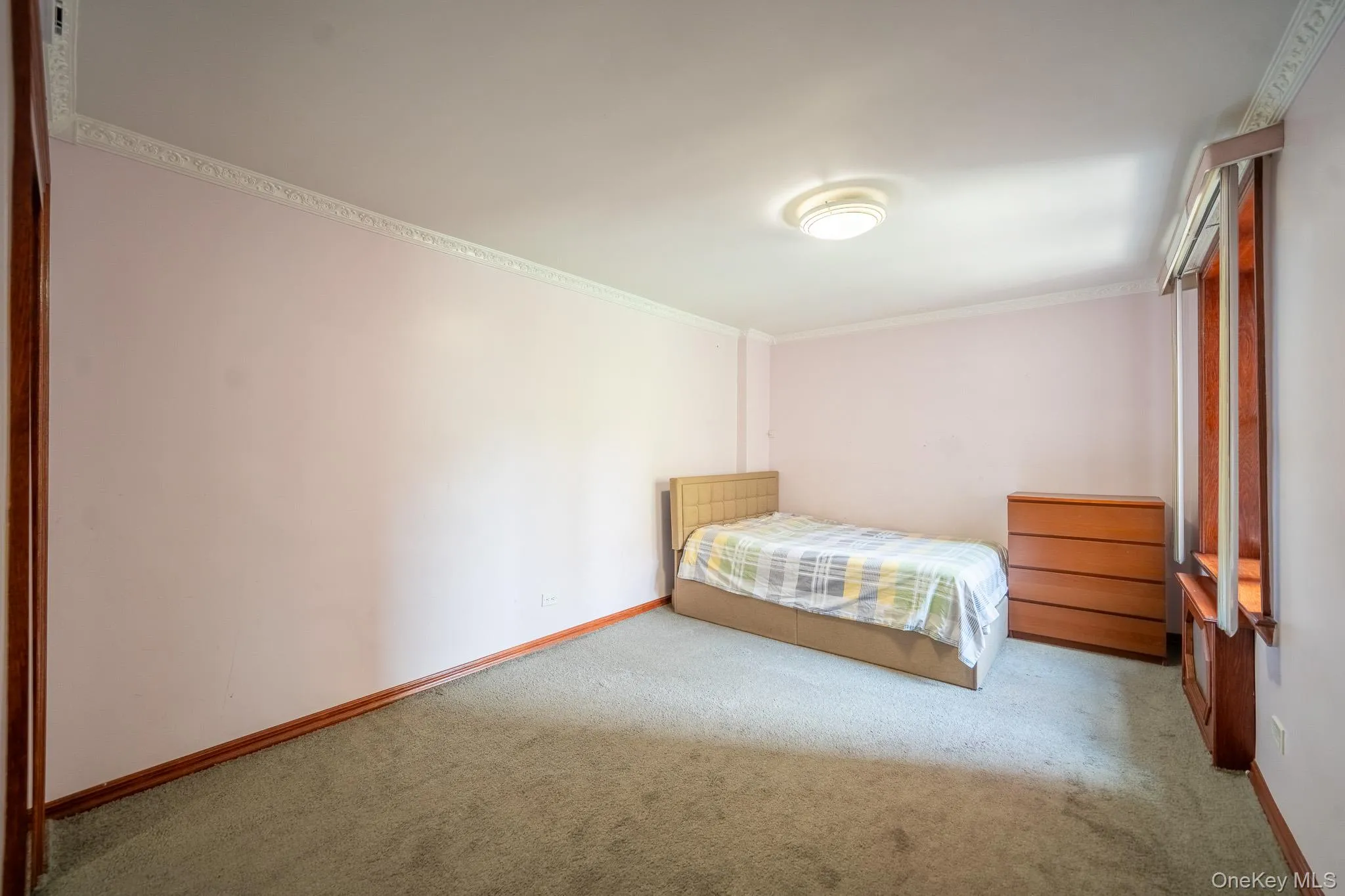 Bedroom featuring carpet floors and ornamental molding Bedroom featuring carpet floors and ornamental molding