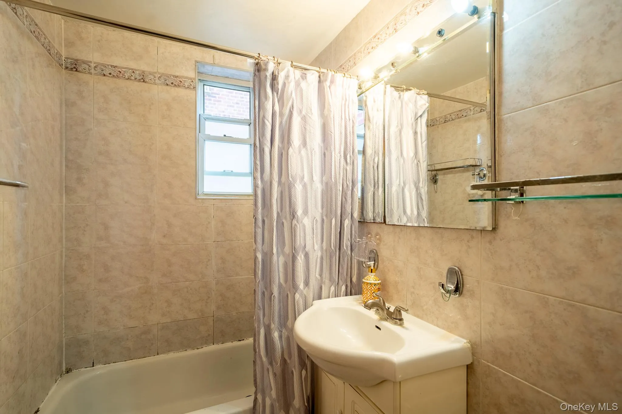 Bathroom featuring shower / tub combo with curtain and vanity Bathroom featuring shower / tub combo with curtain and vanity