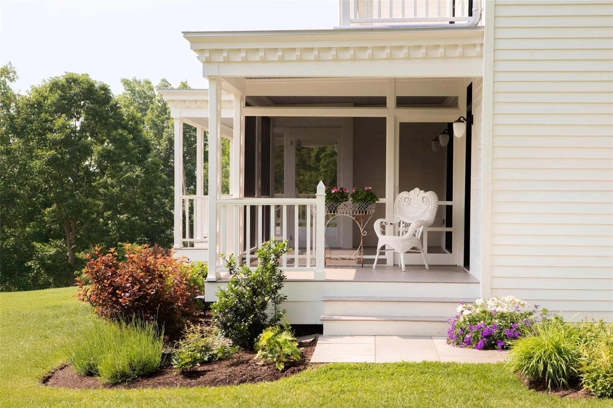 Doorway to property with covered porch and a yard Doorway to property with covered porch and a yard