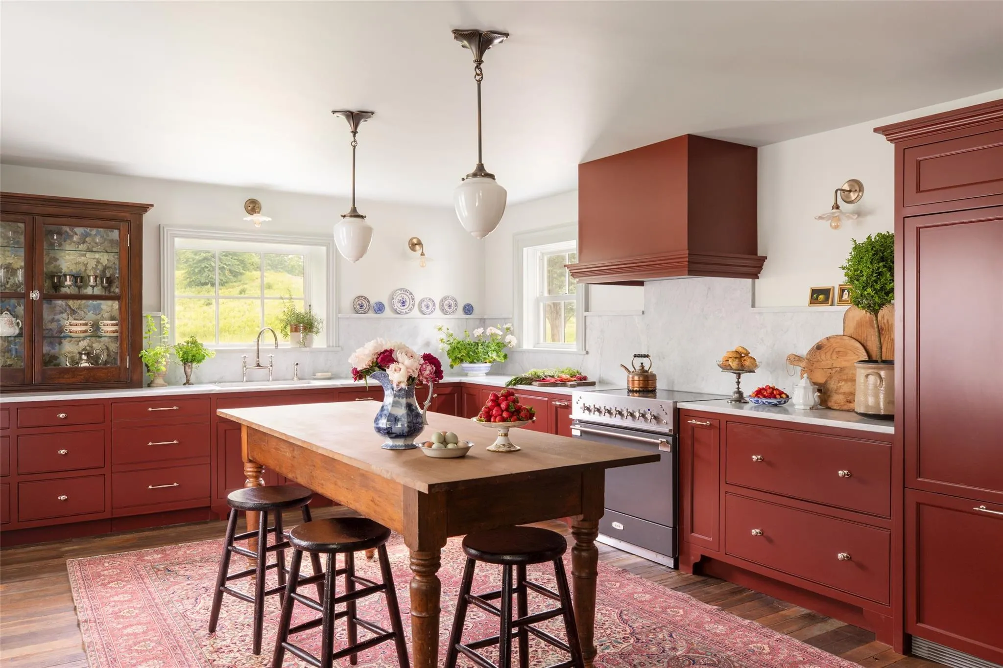 Kitchen with high end stainless steel range, custom range hood, light countertops, dark wood-style floors, and tasteful backsplash Kitchen with high end stainless steel range, custom range hood, light countertops, dark wood-style floors, and tasteful backsplash