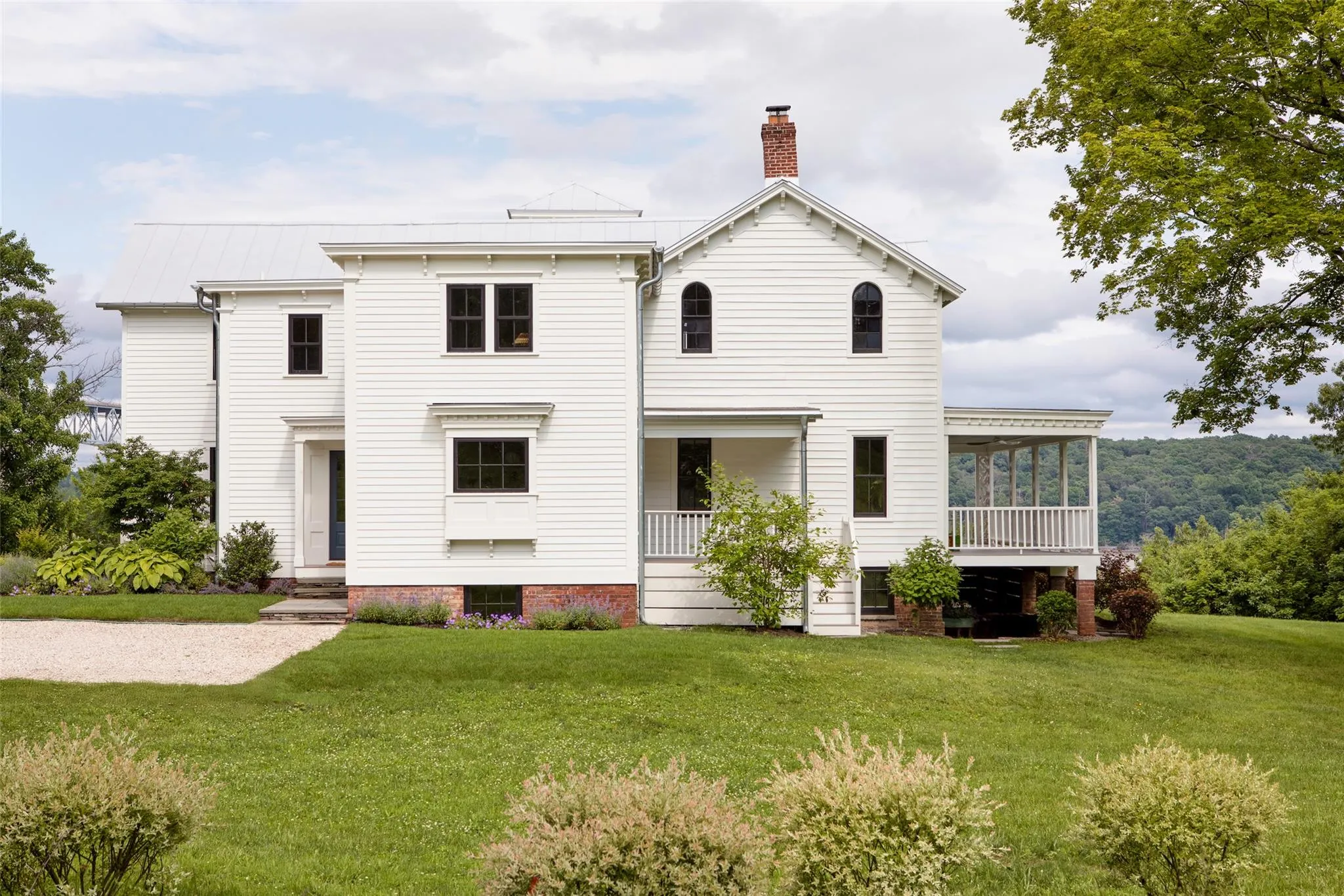 View of front of house featuring a chimney, a front yard, a standing seam roof, and a metal roof View of front of house featuring a chimney, a front yard, a standing seam roof, and a metal roof