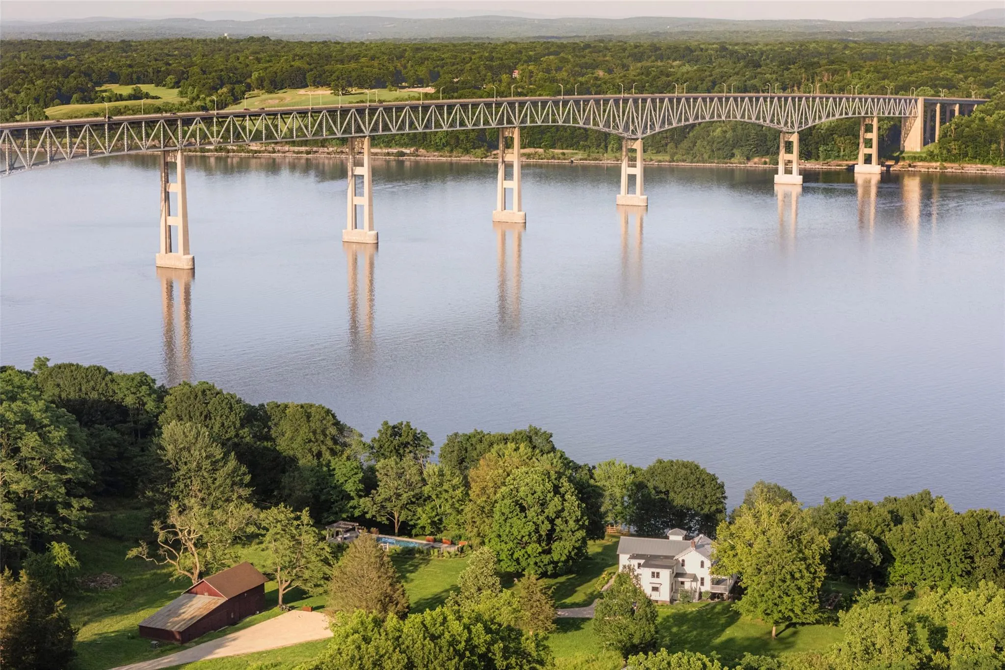 Aerial view of a notable bridge and a heavily wooded area Aerial view of a notable bridge and a heavily wooded area