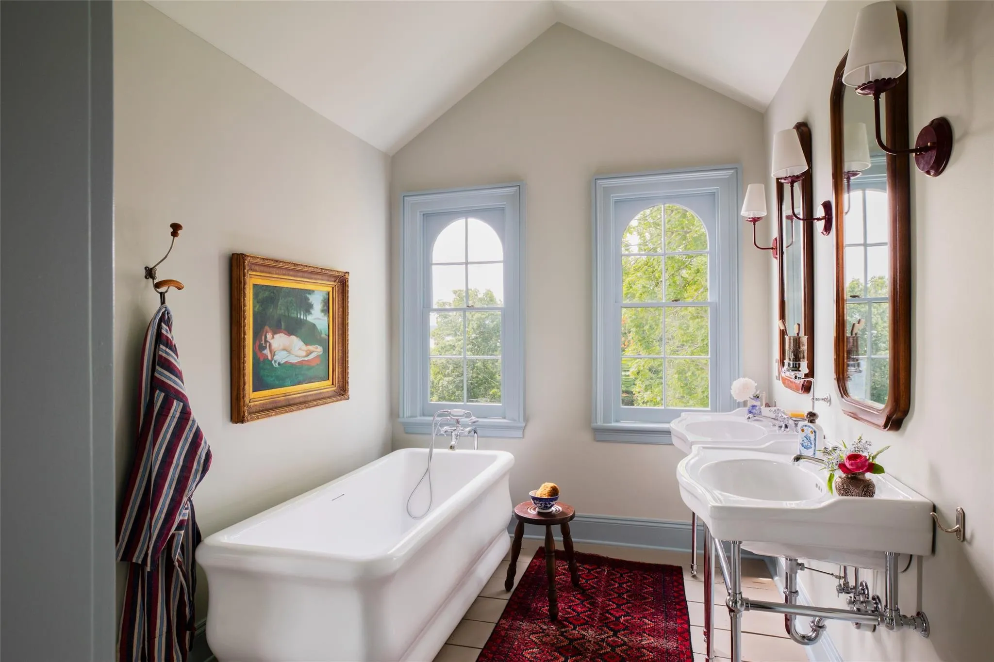 Full bathroom featuring a freestanding bath, tile patterned flooring, and lofted ceiling Full bathroom featuring a freestanding bath, tile patterned flooring, and lofted ceiling