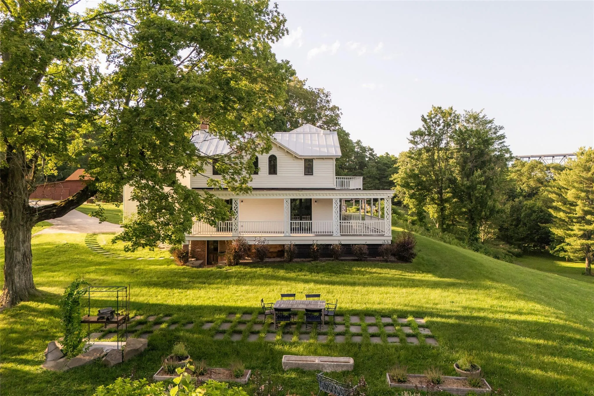 Rear view of house featuring a lawn and a metal roof Rear view of house featuring a lawn and a metal roof