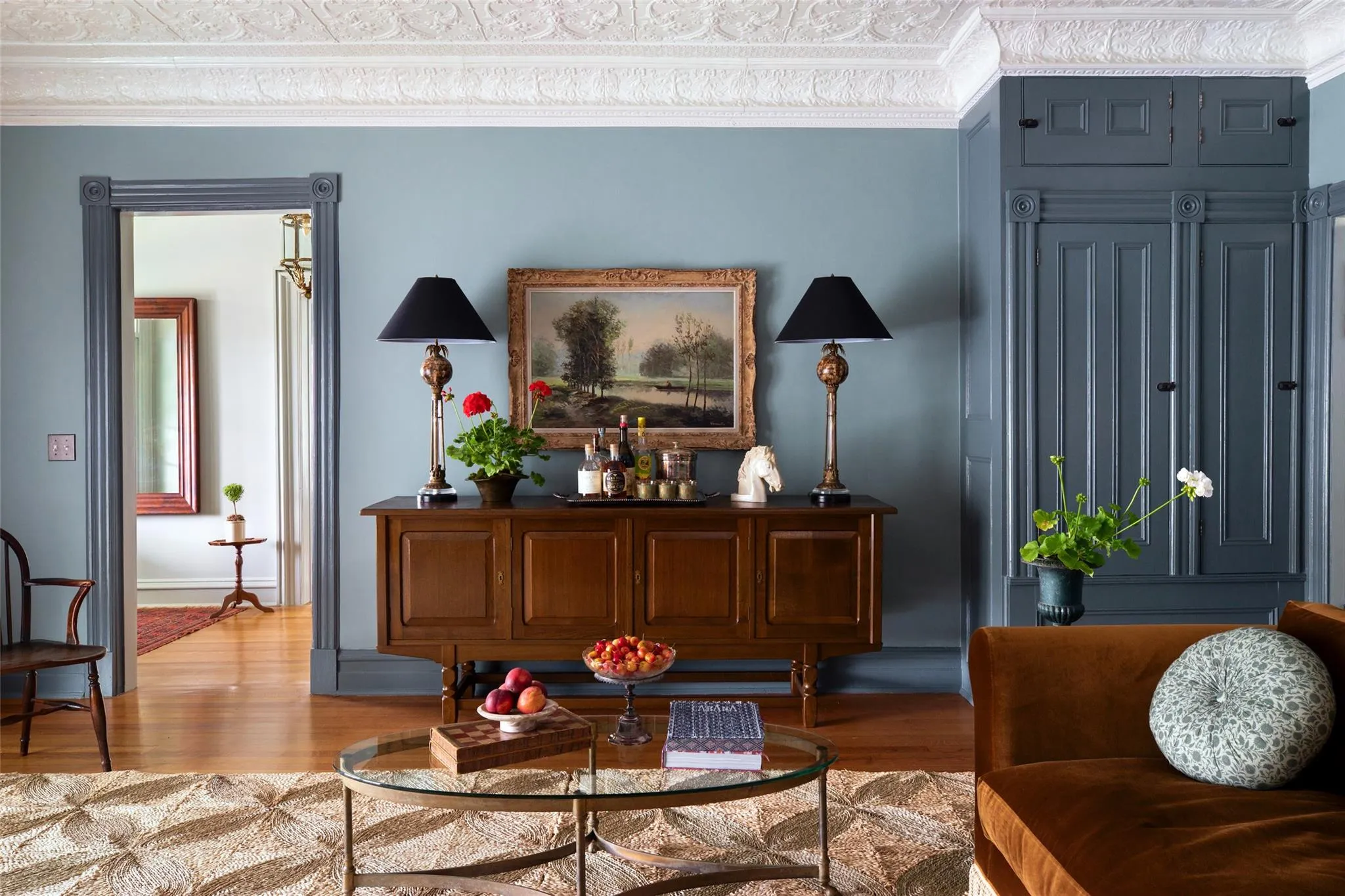 Living area featuring wood finished floors and ornamental molding Living area featuring wood finished floors and ornamental molding