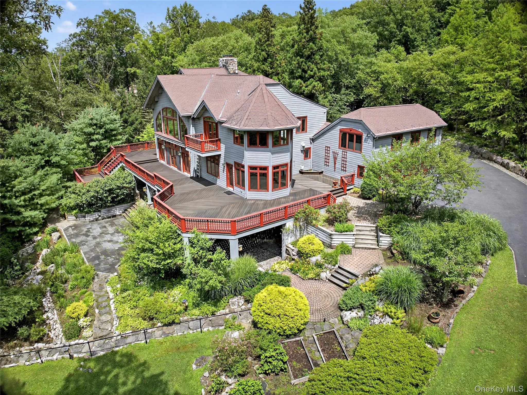 Aerial view of property and surrounding area with a forest Aerial view of property and surrounding area with a forest