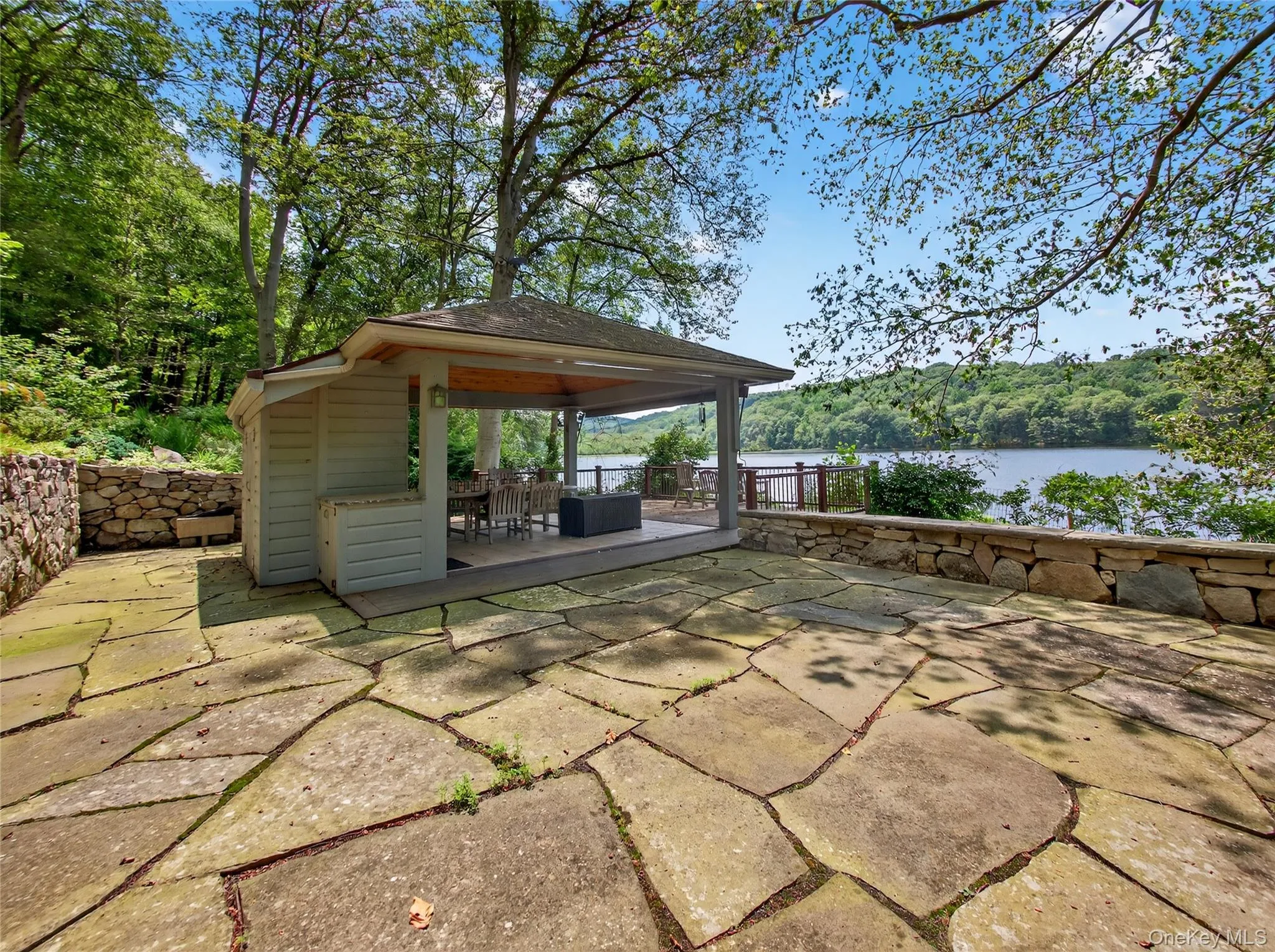 View of patio with a deck with water view and a gazebo View of patio with a deck with water view and a gazebo
