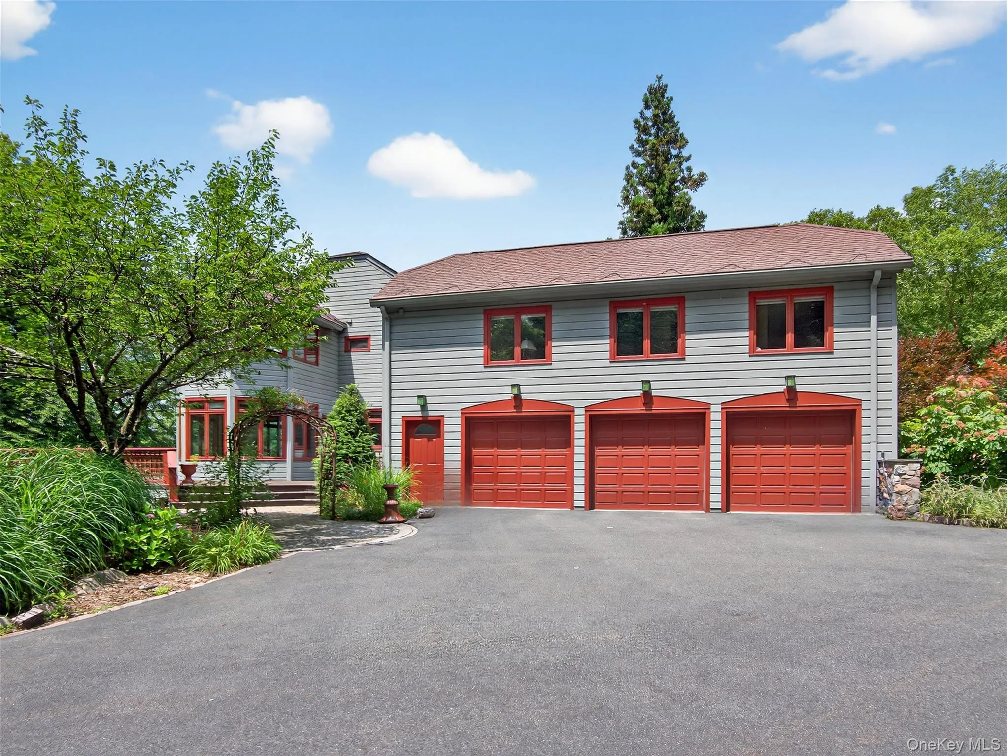 View of front of house featuring asphalt driveway, an attached garage, and roof with shingles View of front of house featuring asphalt driveway, an attached garage, and roof with shingles