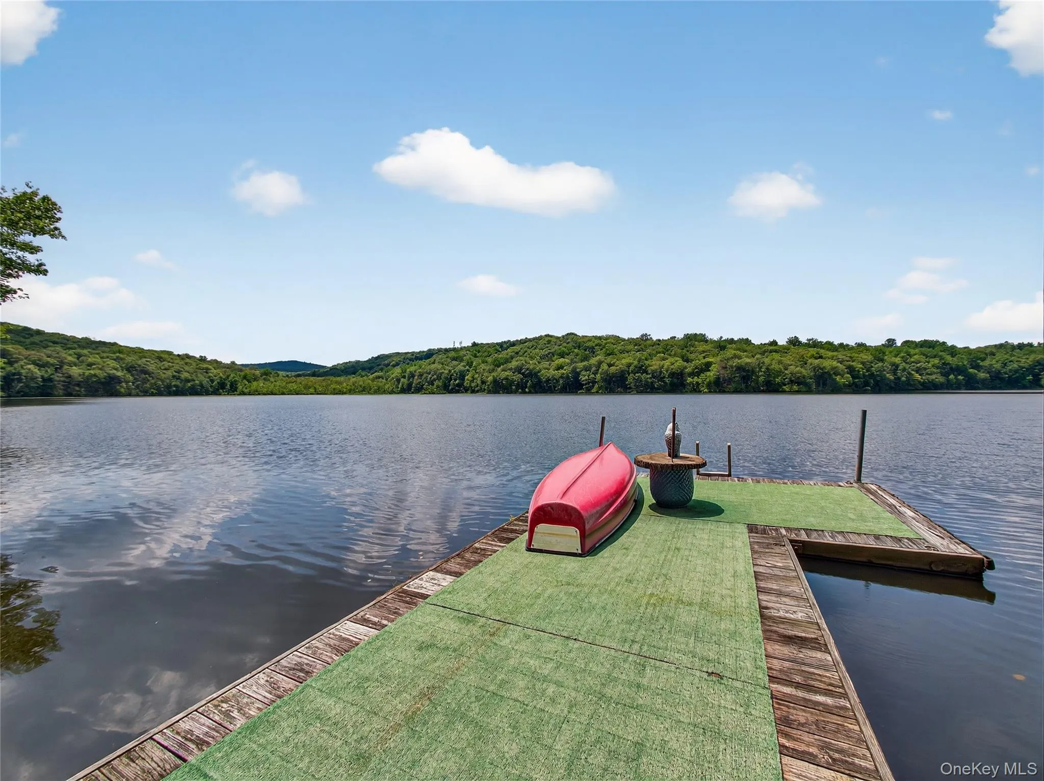 Dock area with a water view and a wooded view Dock area with a water view and a wooded view