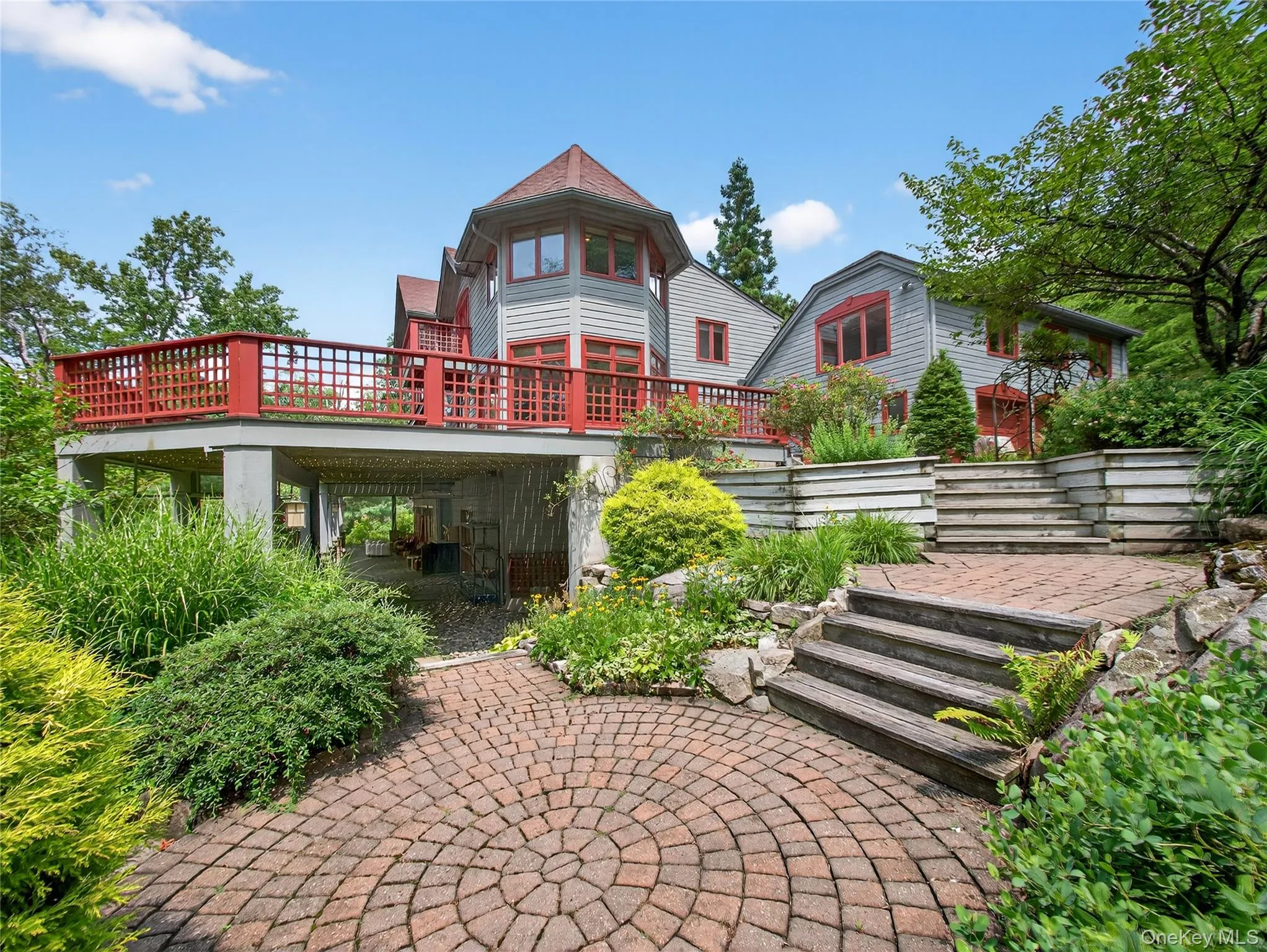 Rear view of house featuring a wooden deck and a patio area Rear view of house featuring a wooden deck and a patio area