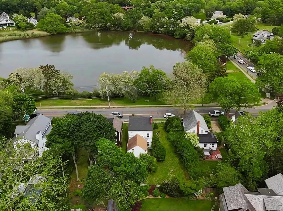 Aerial perspective of suburban area featuring a large body of water Aerial perspective of suburban area featuring a large body of water