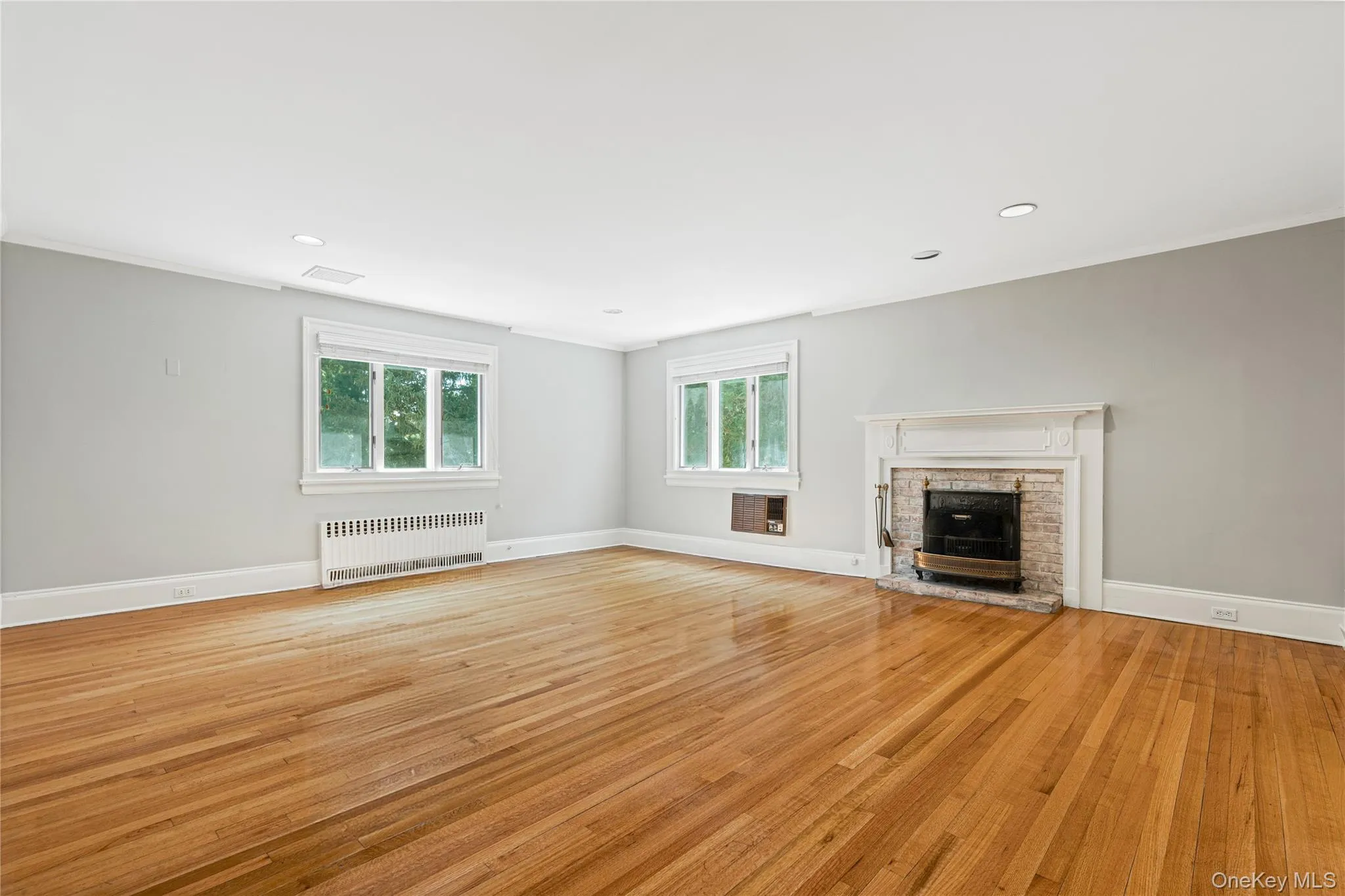 Primary Bedroom features a wood burning fireplace, newly finished wood floors throughout Primary Bedroom features a wood burning fireplace, newly finished wood floors throughout