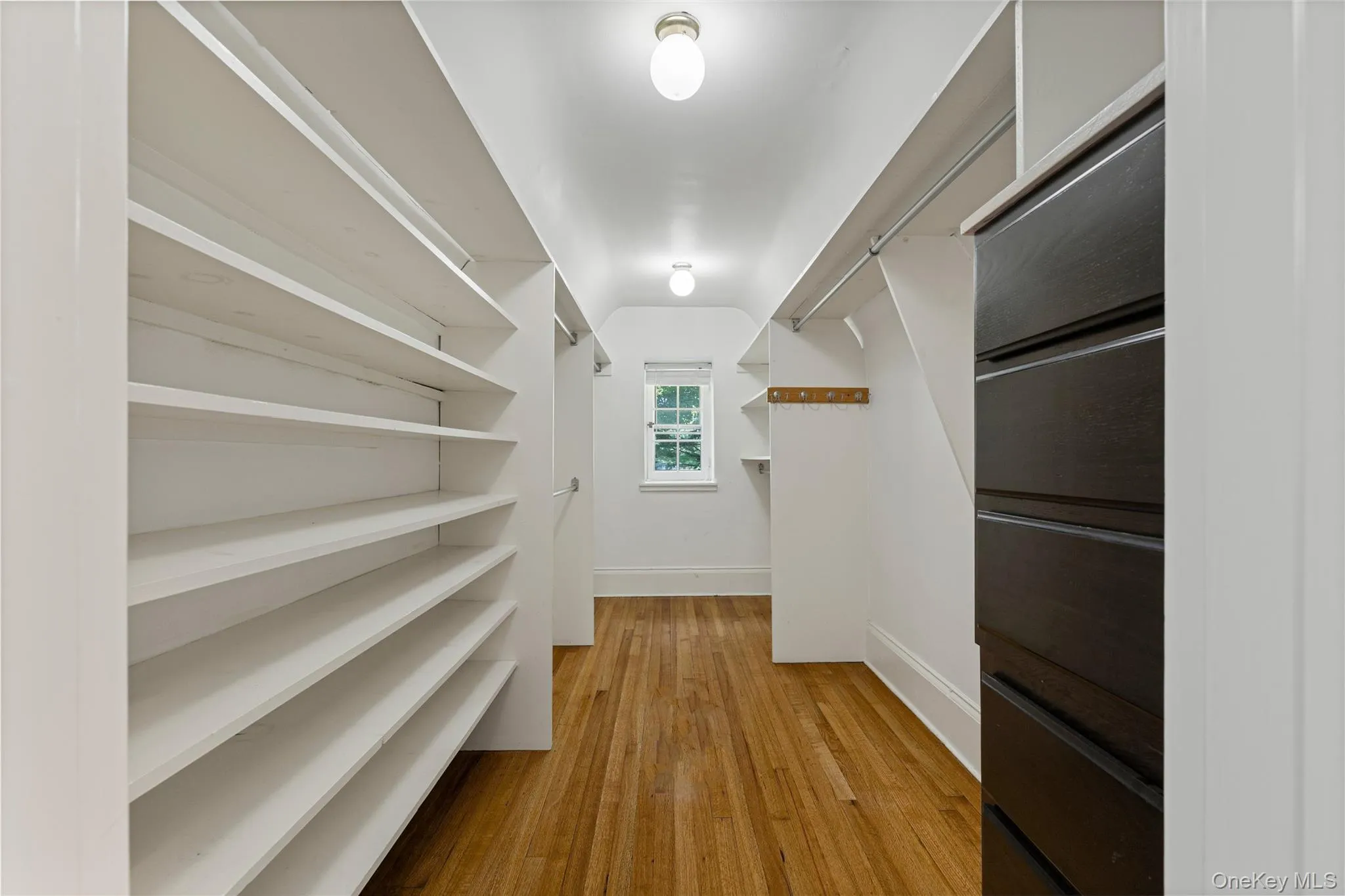 Deep walk in closet ensuite with the primary bedroom and bathroom Deep walk in closet ensuite with the primary bedroom and bathroom