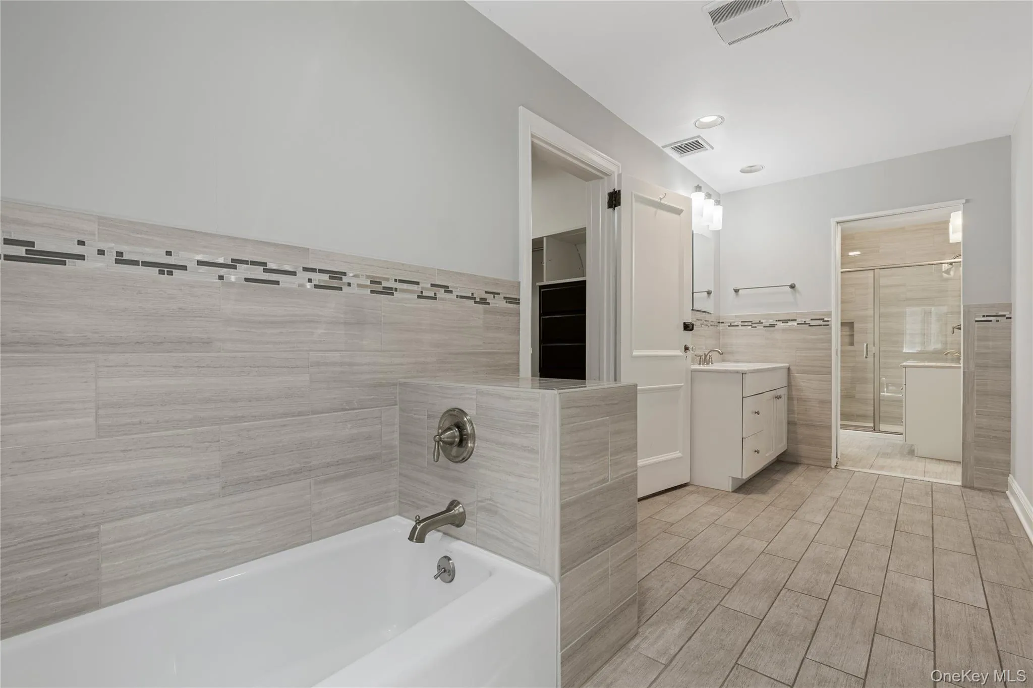 Ensuite Primary Bathroom with two separate areas, one with a tub and vanity... Ensuite Primary Bathroom with two separate areas, one with a tub and vanity...