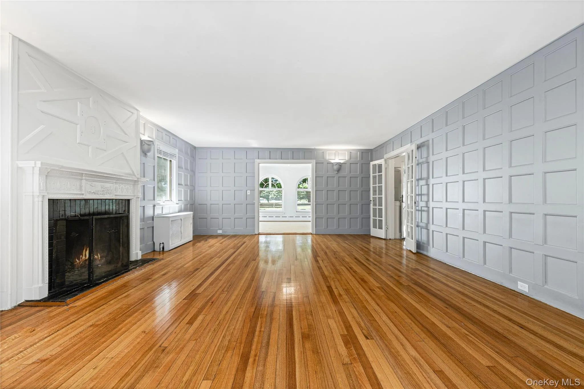 Spacious Living Room featuring spectacular wood paneling detail, wood burning fireplace, access to the family room, and ... Spacious Living Room featuring spectacular wood paneling detail, wood burning fireplace, access to the family room, and ...