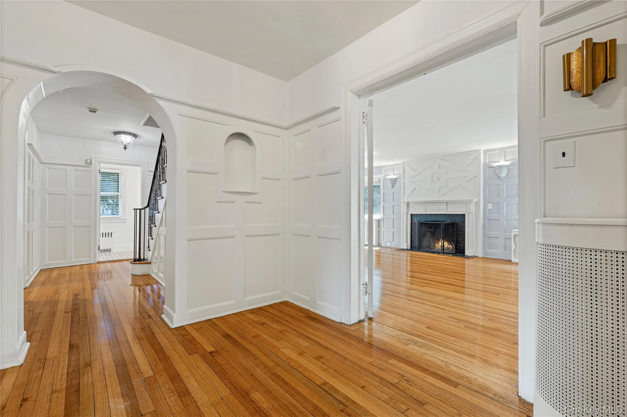 Entry Hall showing custom wood paneling and wide doorway to the Living Room Entry Hall showing custom wood paneling and wide doorway to the Living Room