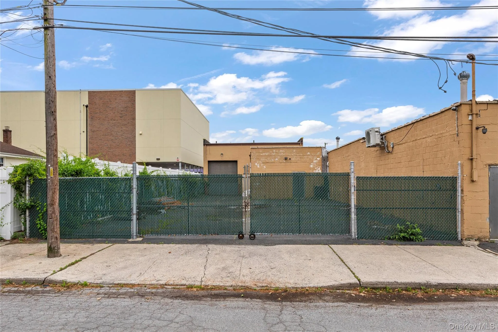 View of building exterior with a fenced front yard View of building exterior with a fenced front yard