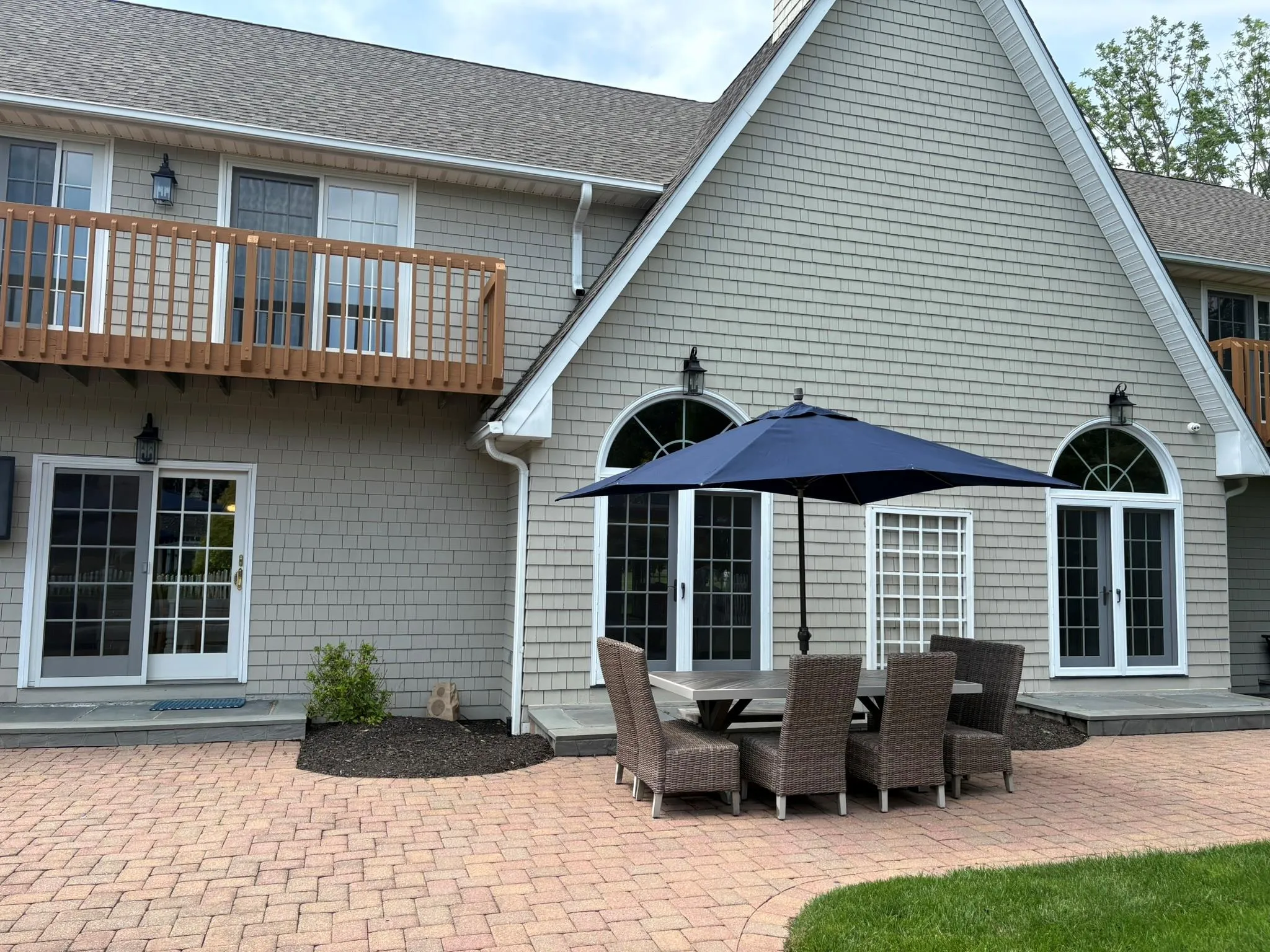 Back of house with french doors, a patio area, a shingled roof, and a balcony Back of house with french doors, a patio area, a shingled roof, and a balcony