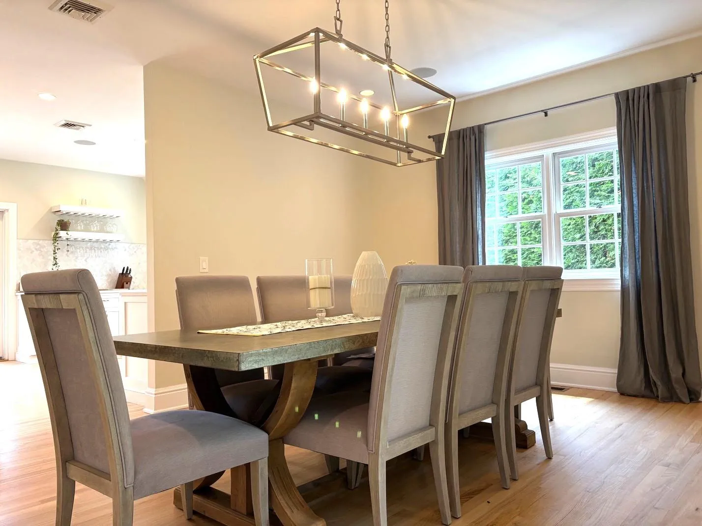 Dining space featuring a chandelier and light wood-style floors Dining space featuring a chandelier and light wood-style floors