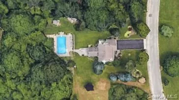 Aerial view of property and surrounding area featuring a pool Aerial view of property and surrounding area featuring a pool