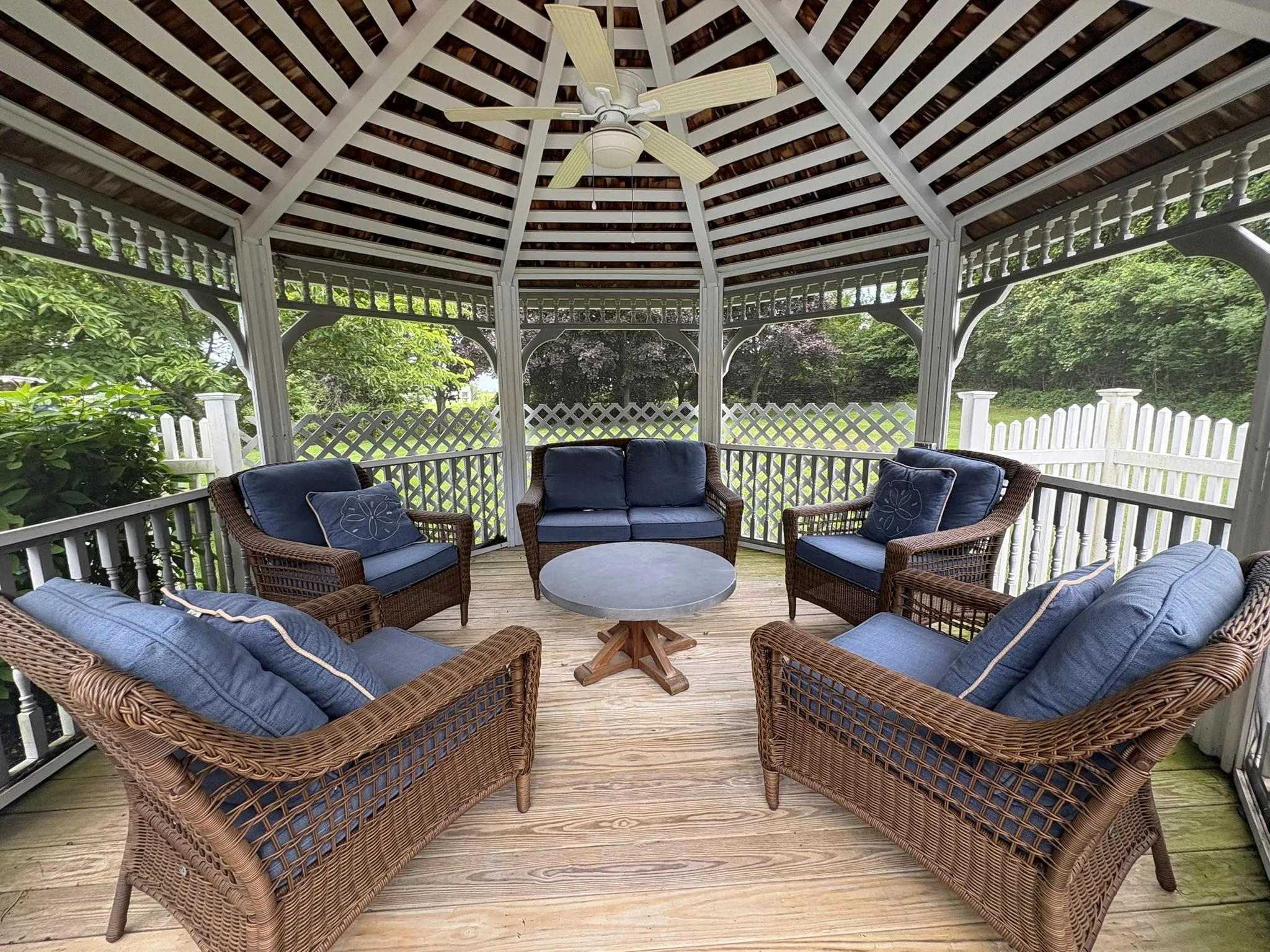 Wooden terrace featuring a gazebo, ceiling fan, and outdoor lounge area Wooden terrace featuring a gazebo, ceiling fan, and outdoor lounge area