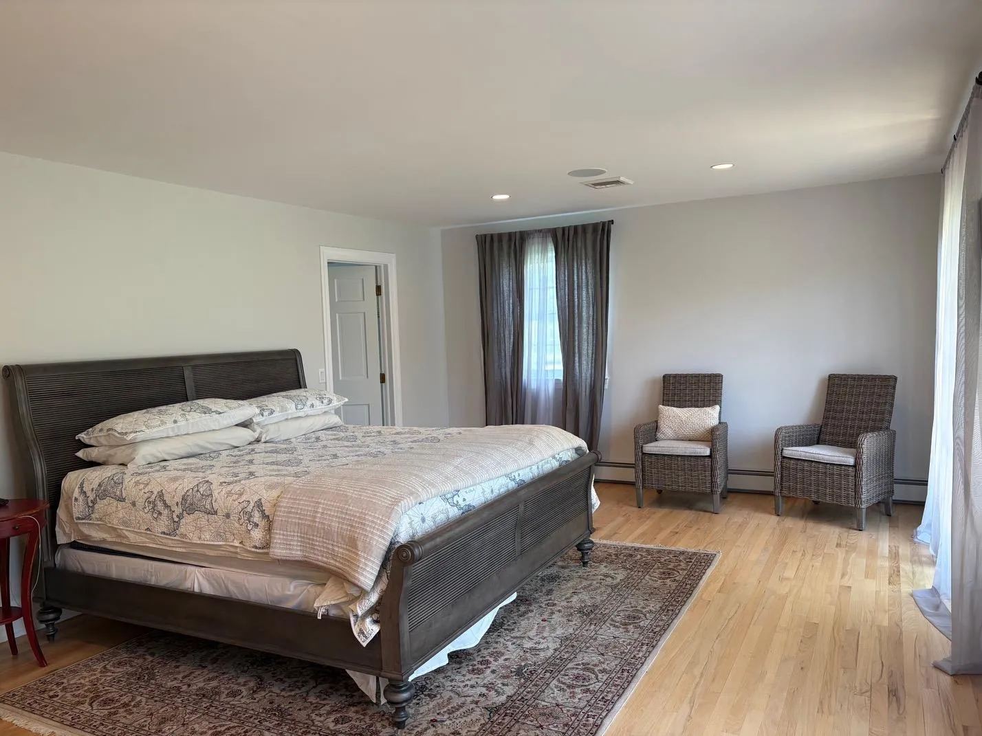 Bedroom featuring a baseboard heating unit, light wood-style flooring, and recessed lighting Bedroom featuring a baseboard heating unit, light wood-style flooring, and recessed lighting