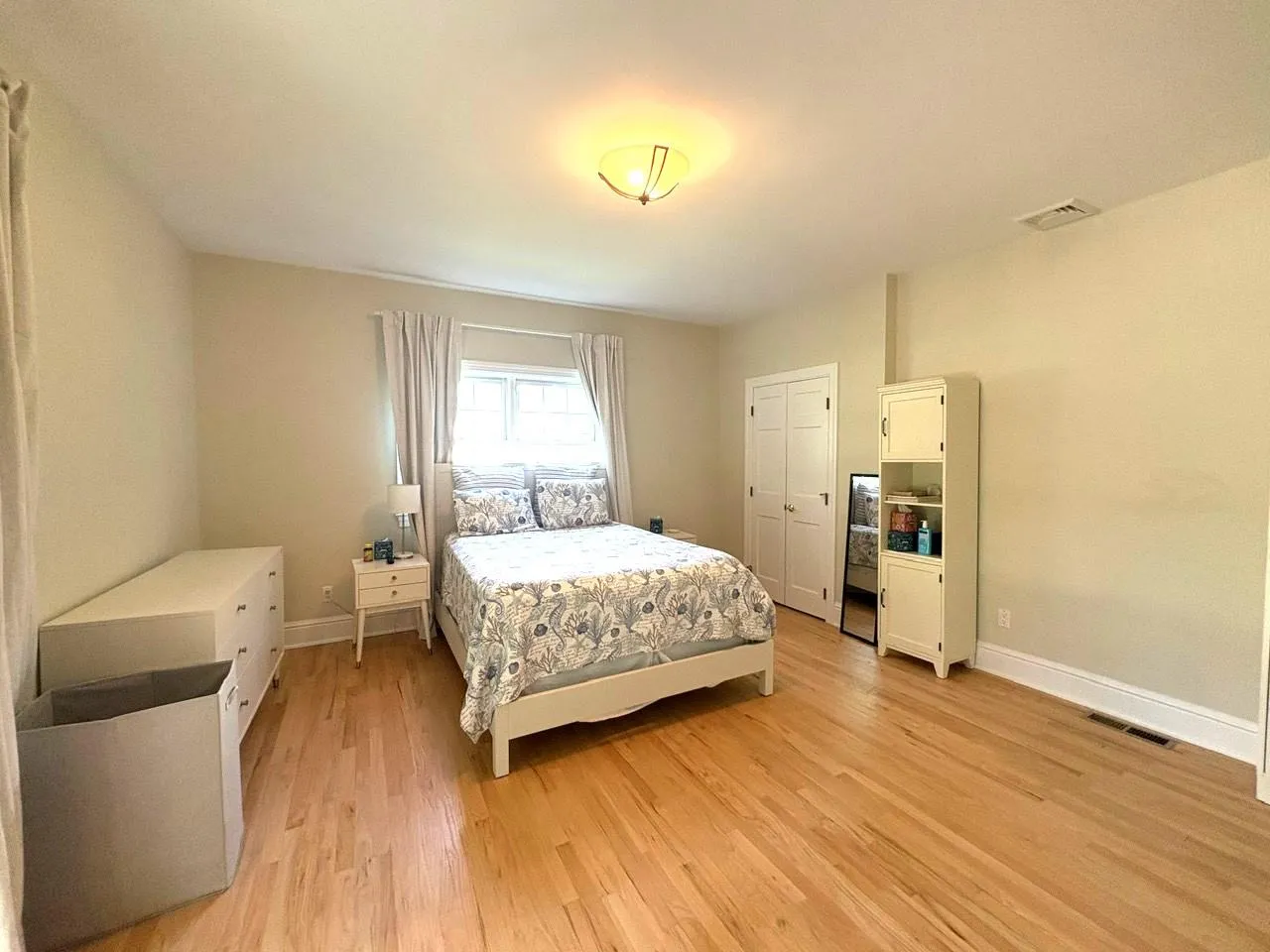 Bedroom with light wood finished floors and baseboards Bedroom with light wood finished floors and baseboards