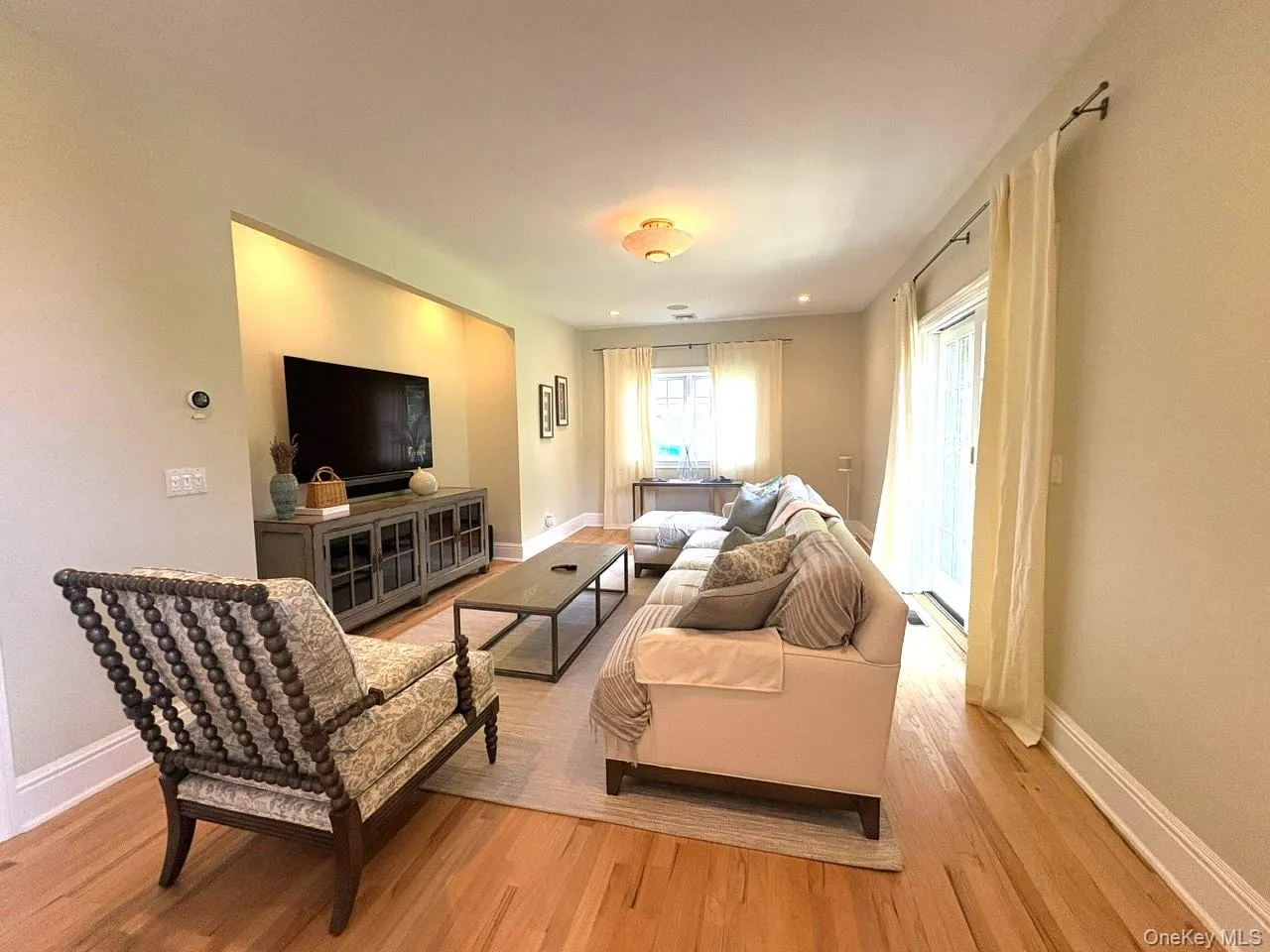 Living area featuring light wood-style flooring and baseboards Living area featuring light wood-style flooring and baseboards