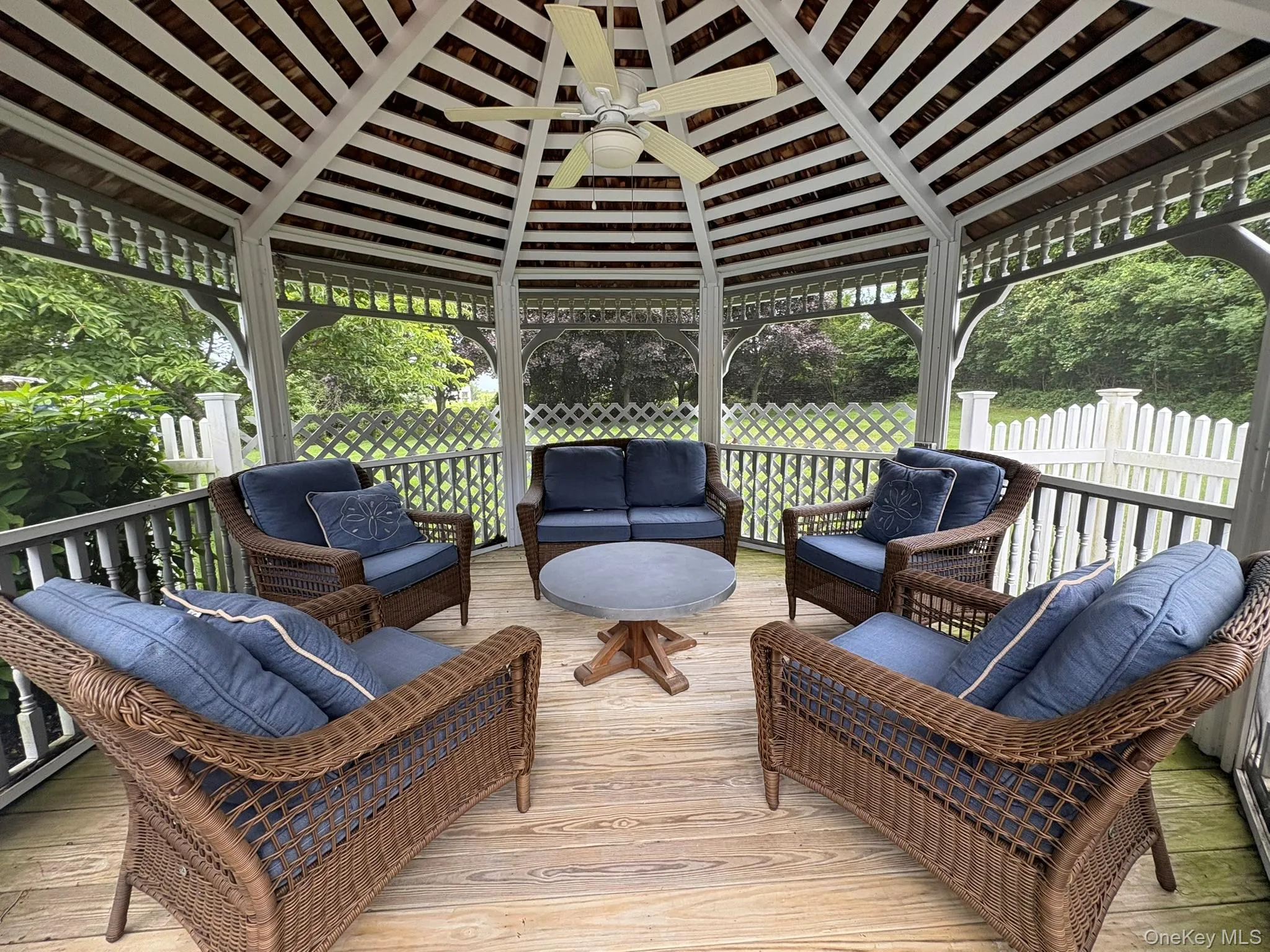 Wooden terrace featuring a gazebo, ceiling fan, and outdoor lounge area Wooden terrace featuring a gazebo, ceiling fan, and outdoor lounge area