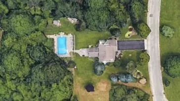 Aerial view of property and surrounding area featuring a pool Aerial view of property and surrounding area featuring a pool