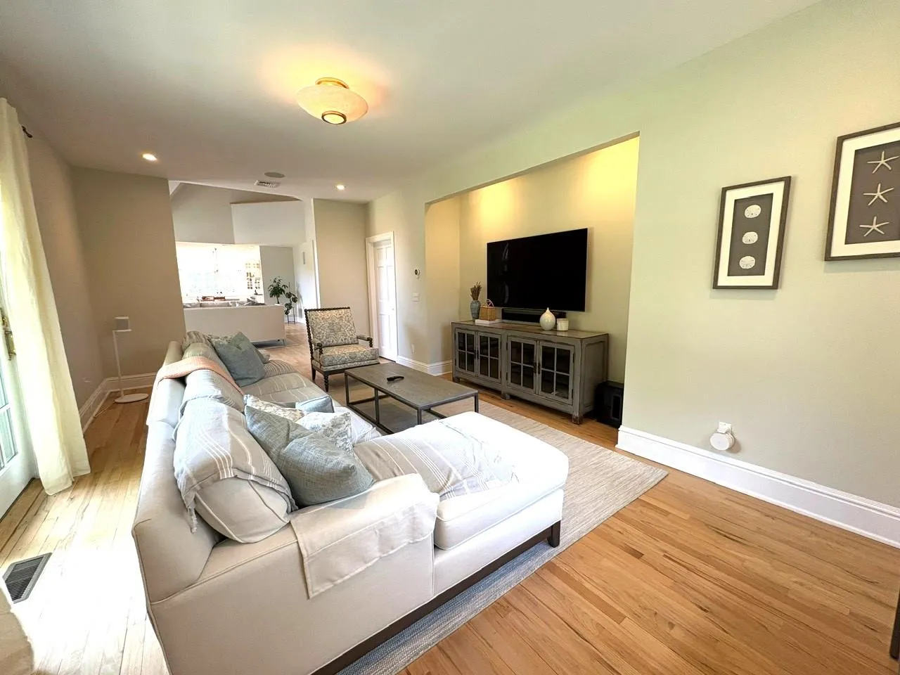 Living area featuring wood finished floors and recessed lighting Living area featuring wood finished floors and recessed lighting